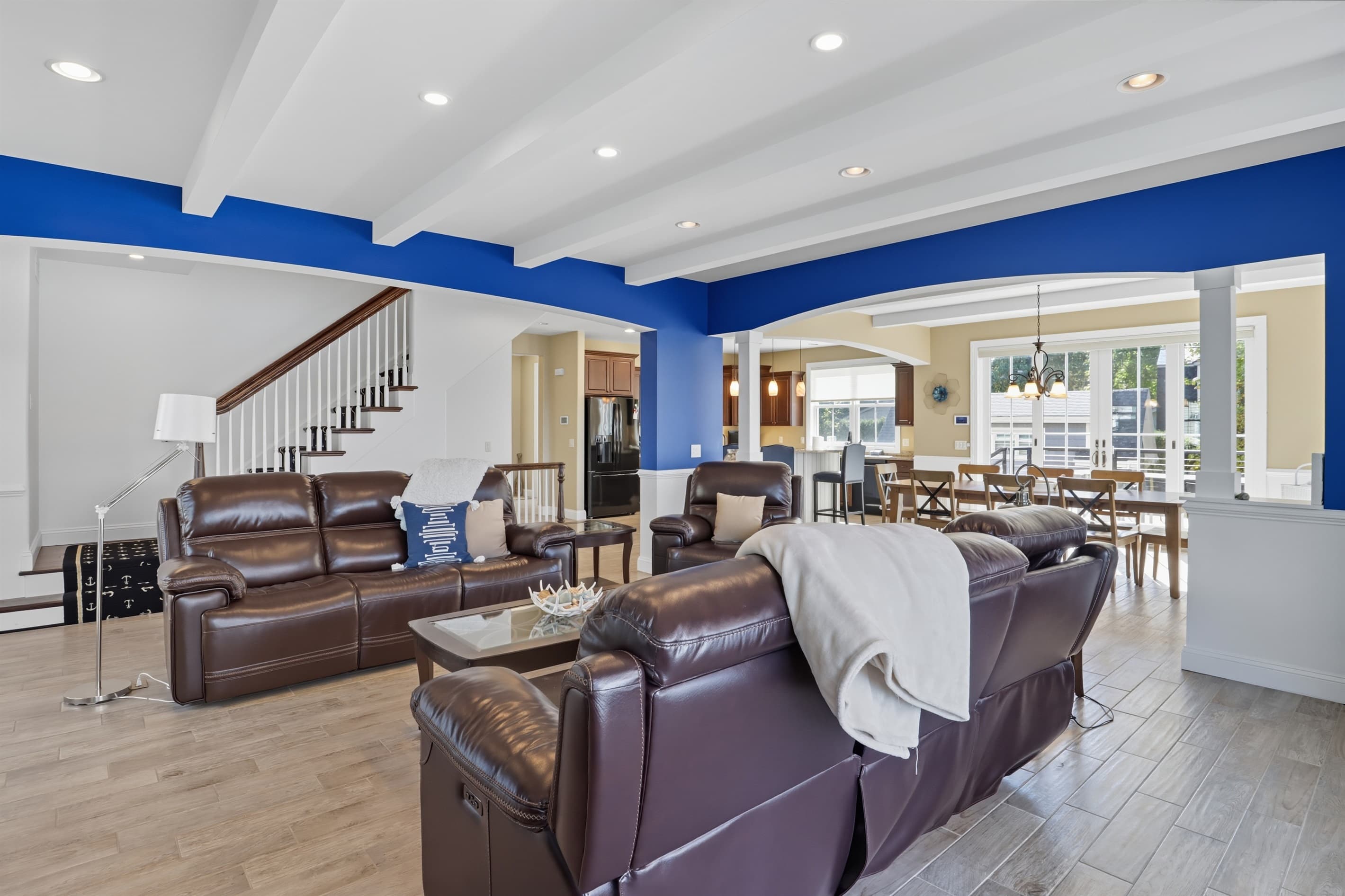 Living room with leather seating and staircase