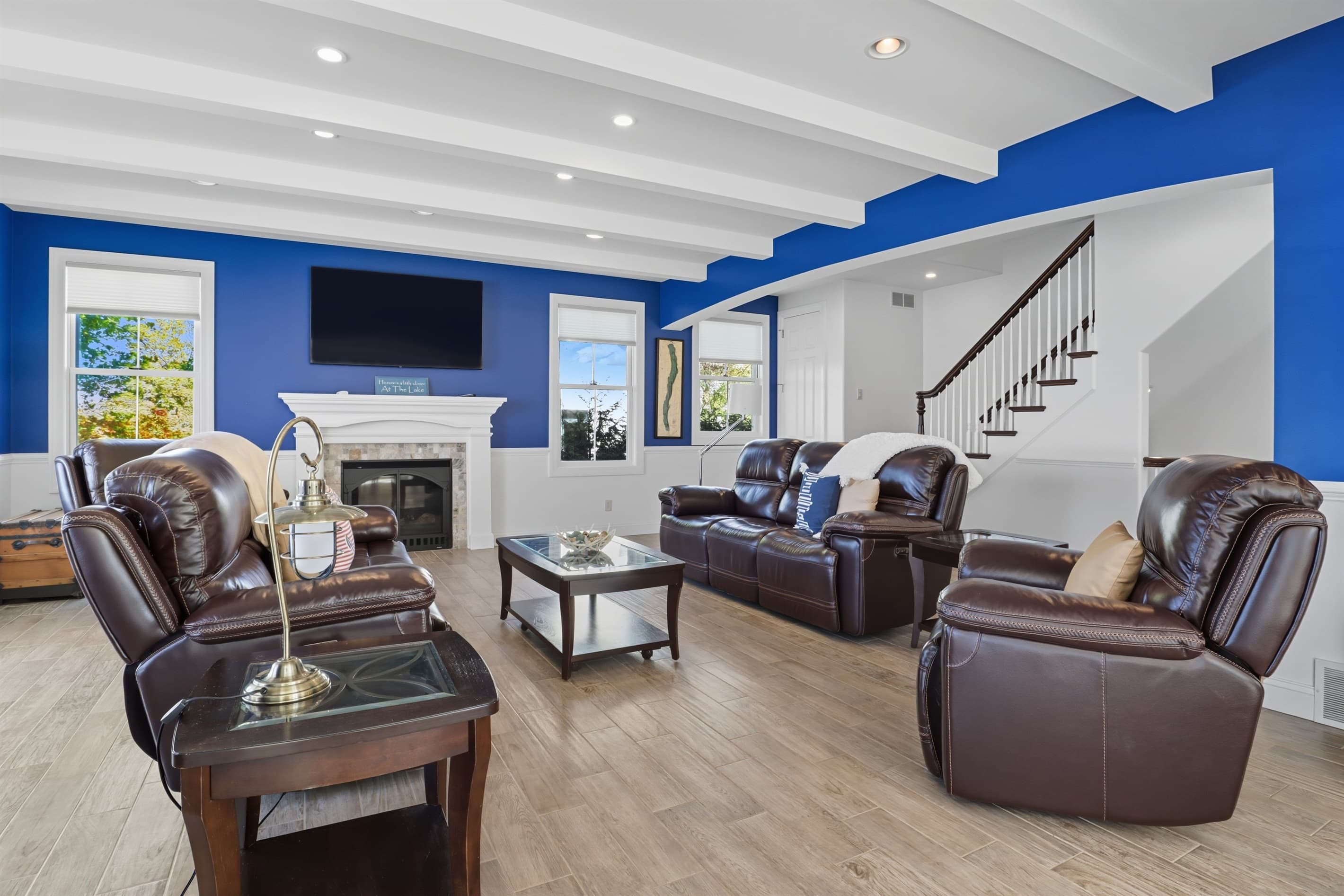 Blue accent wall behind television and fireplace