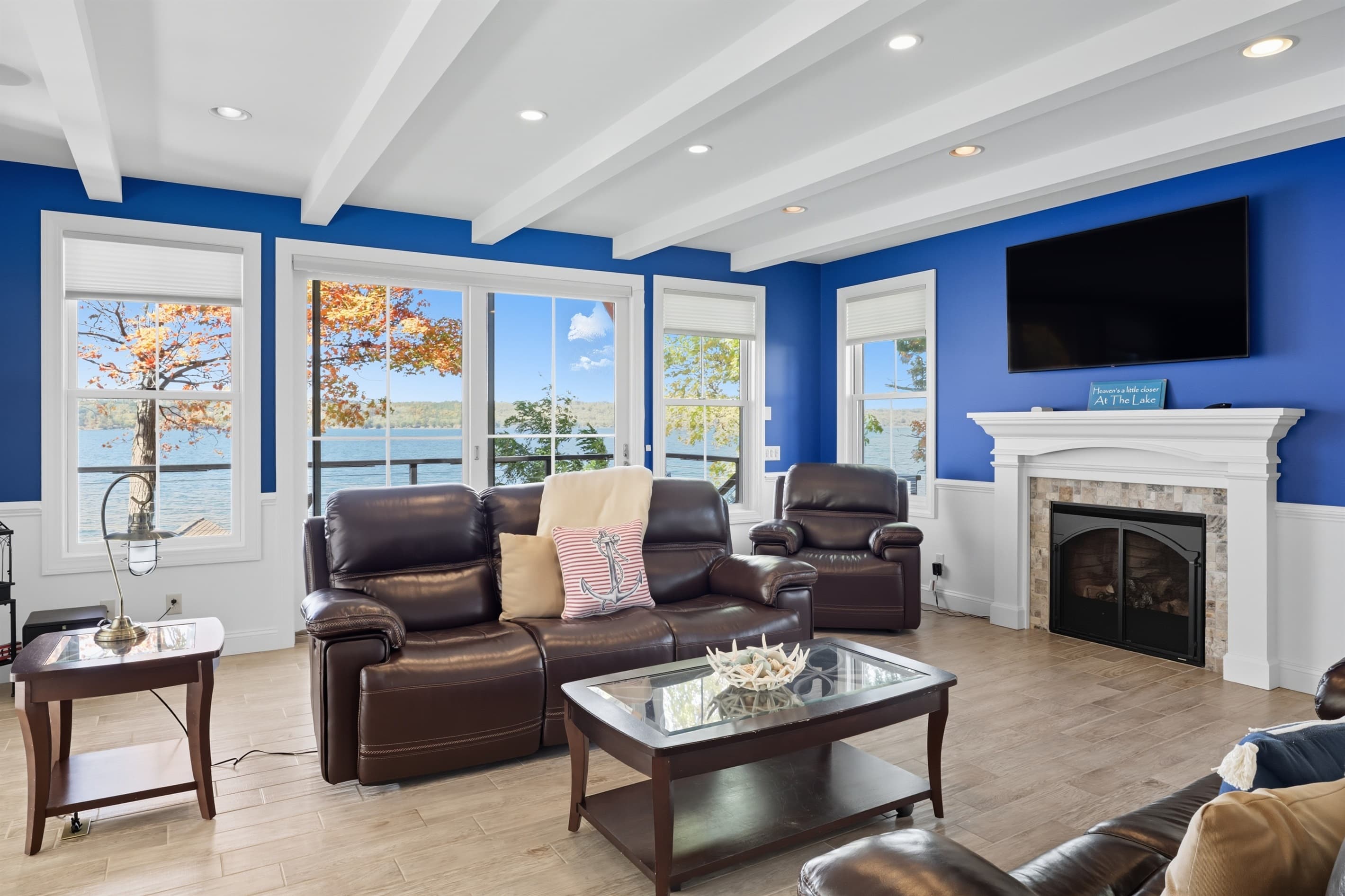 Window-lined living room with leather armchairs
