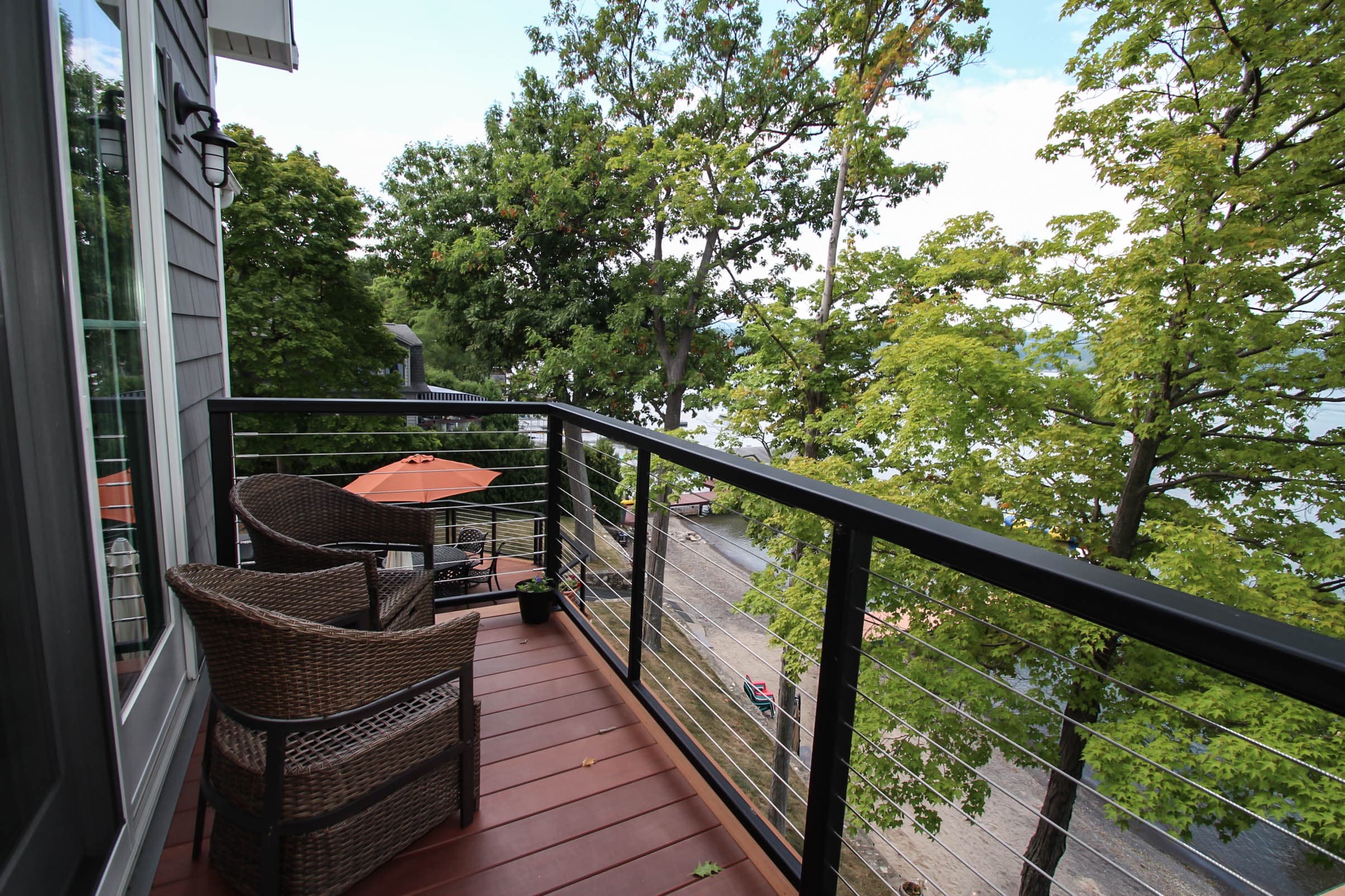 Private balcony with seating area overlooking the lake
