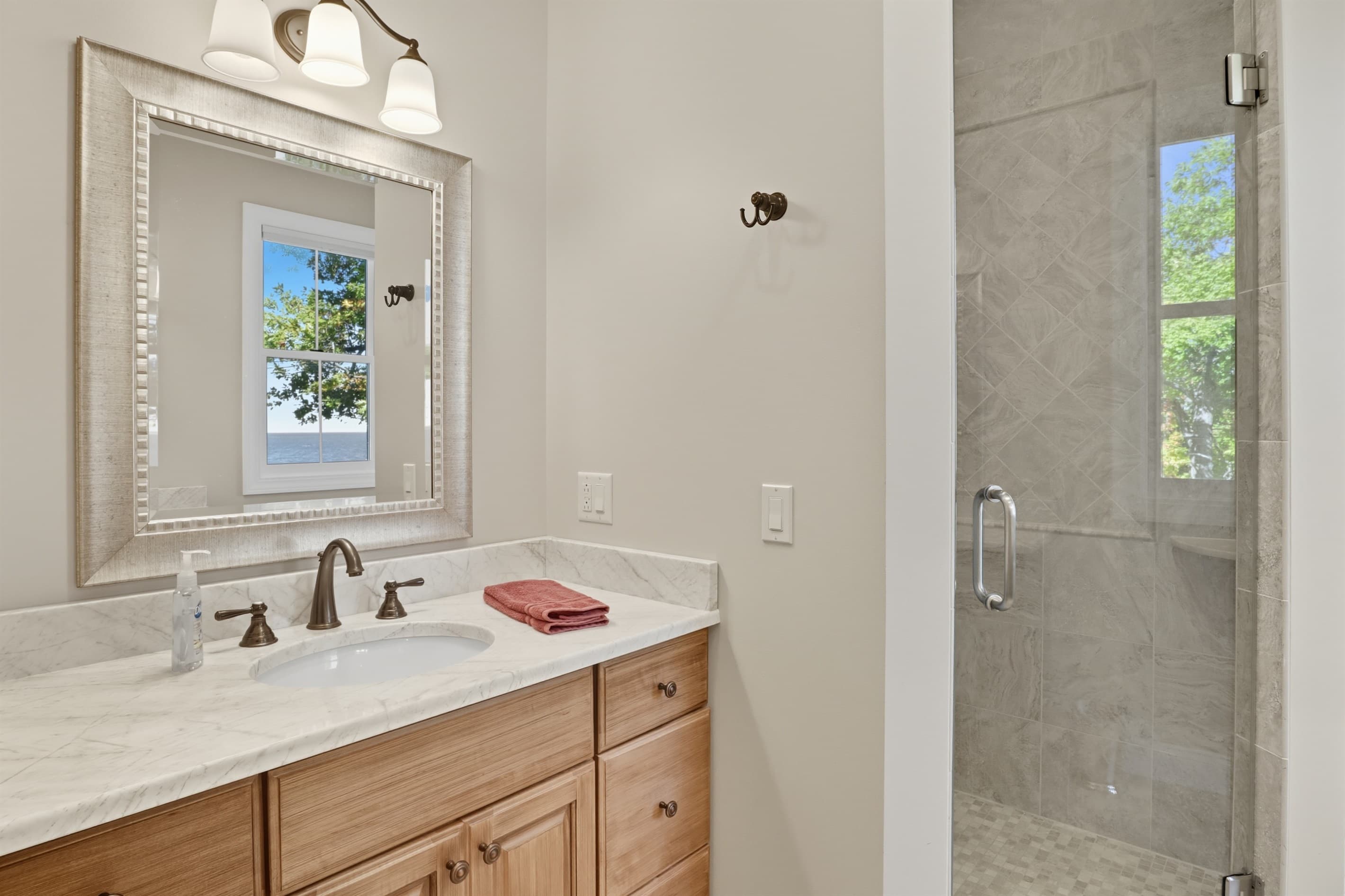 Vanity beside glass-enclosed shower