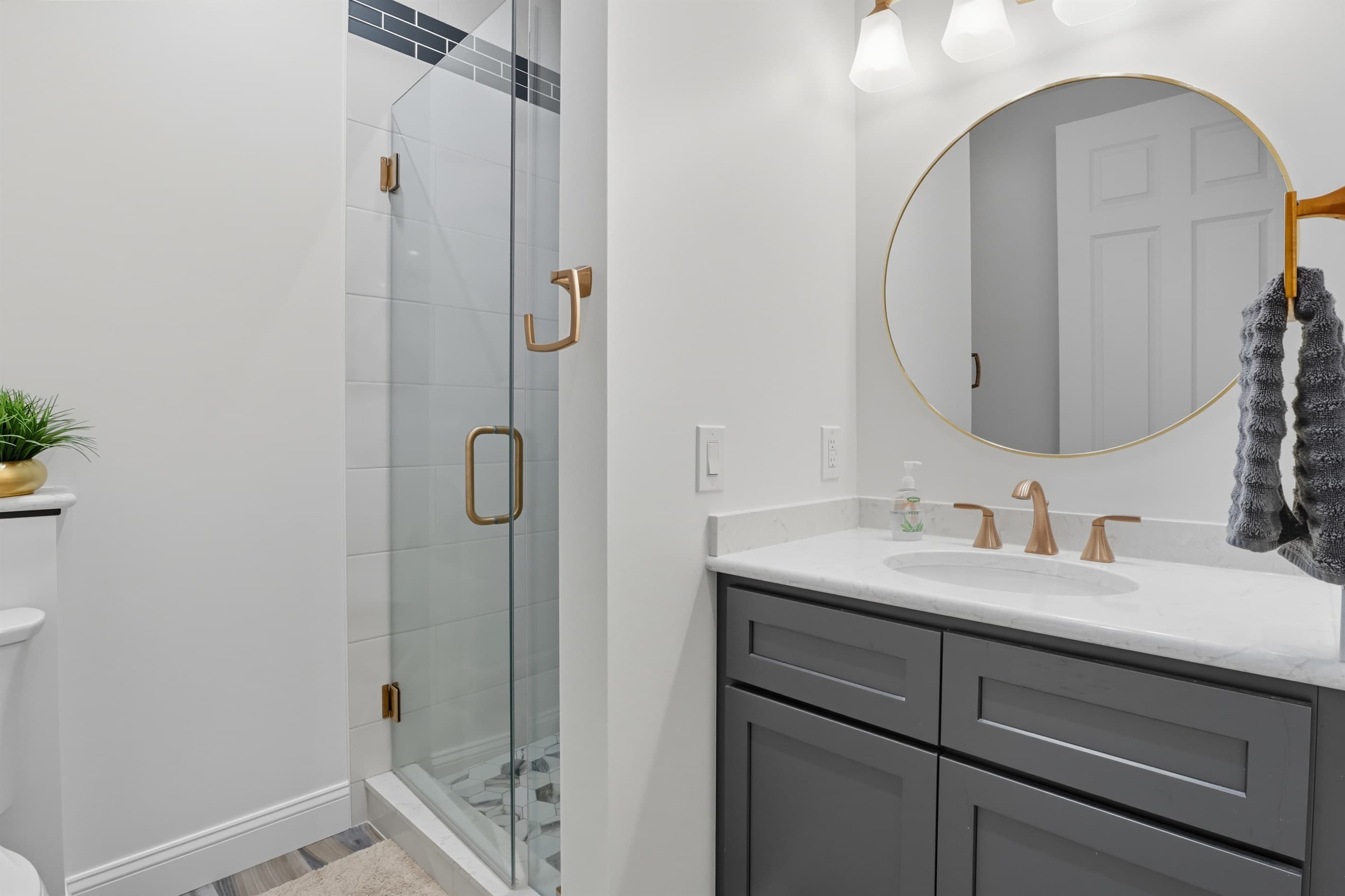 Bathroom vanity beside patterned shower curtain