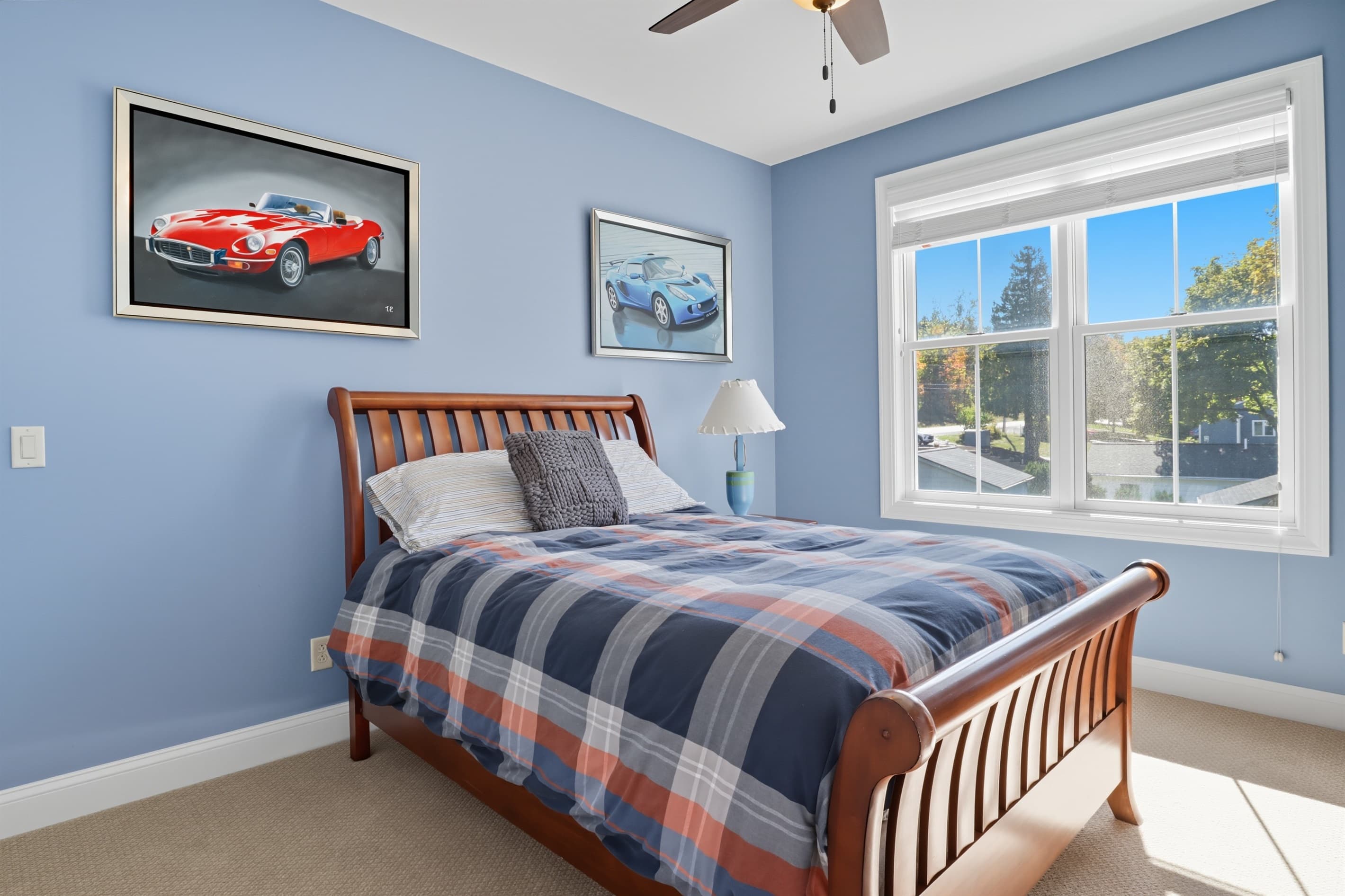 Blue bedroom with wooden bed frame