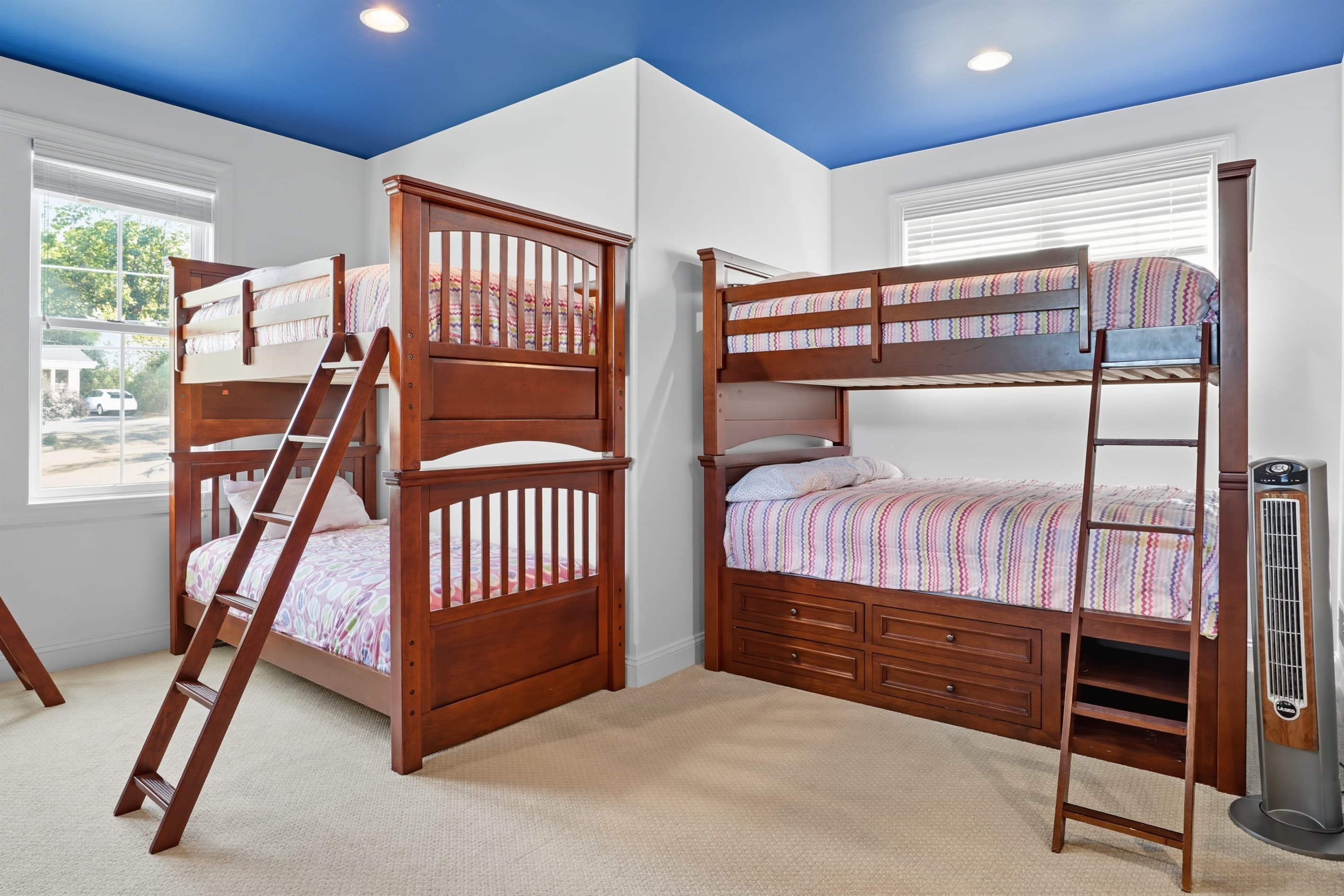 Wooden bunk beds beside large window