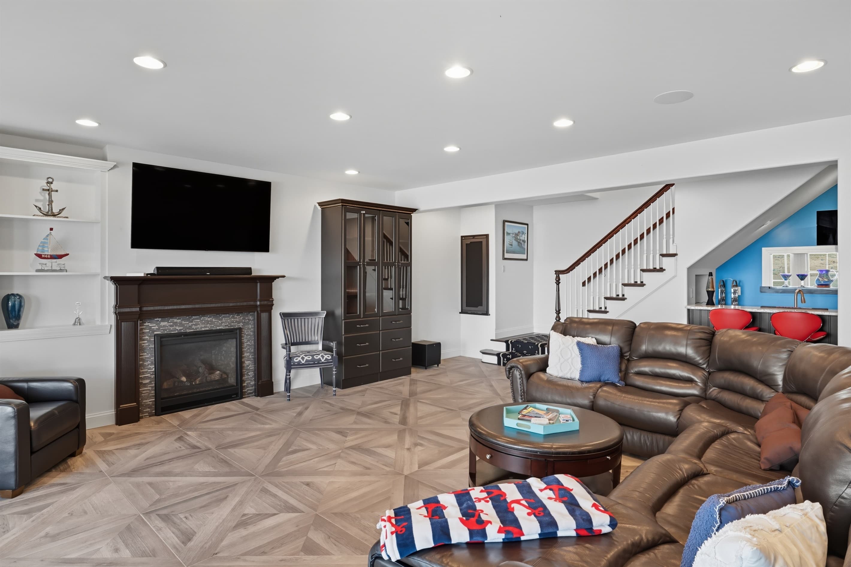 Lower living room with fireplace and television