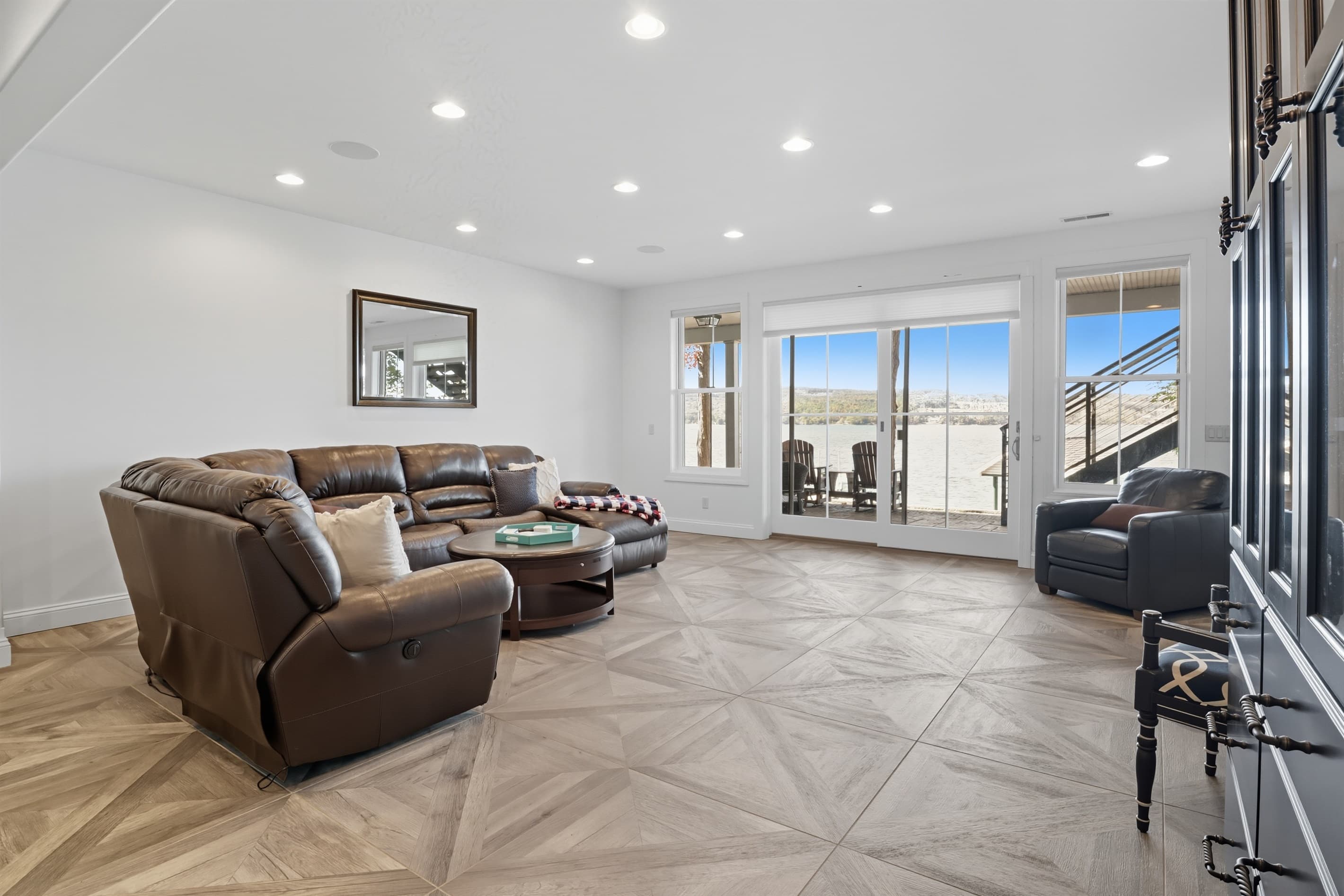 Lounge seating beside large windows and glass door