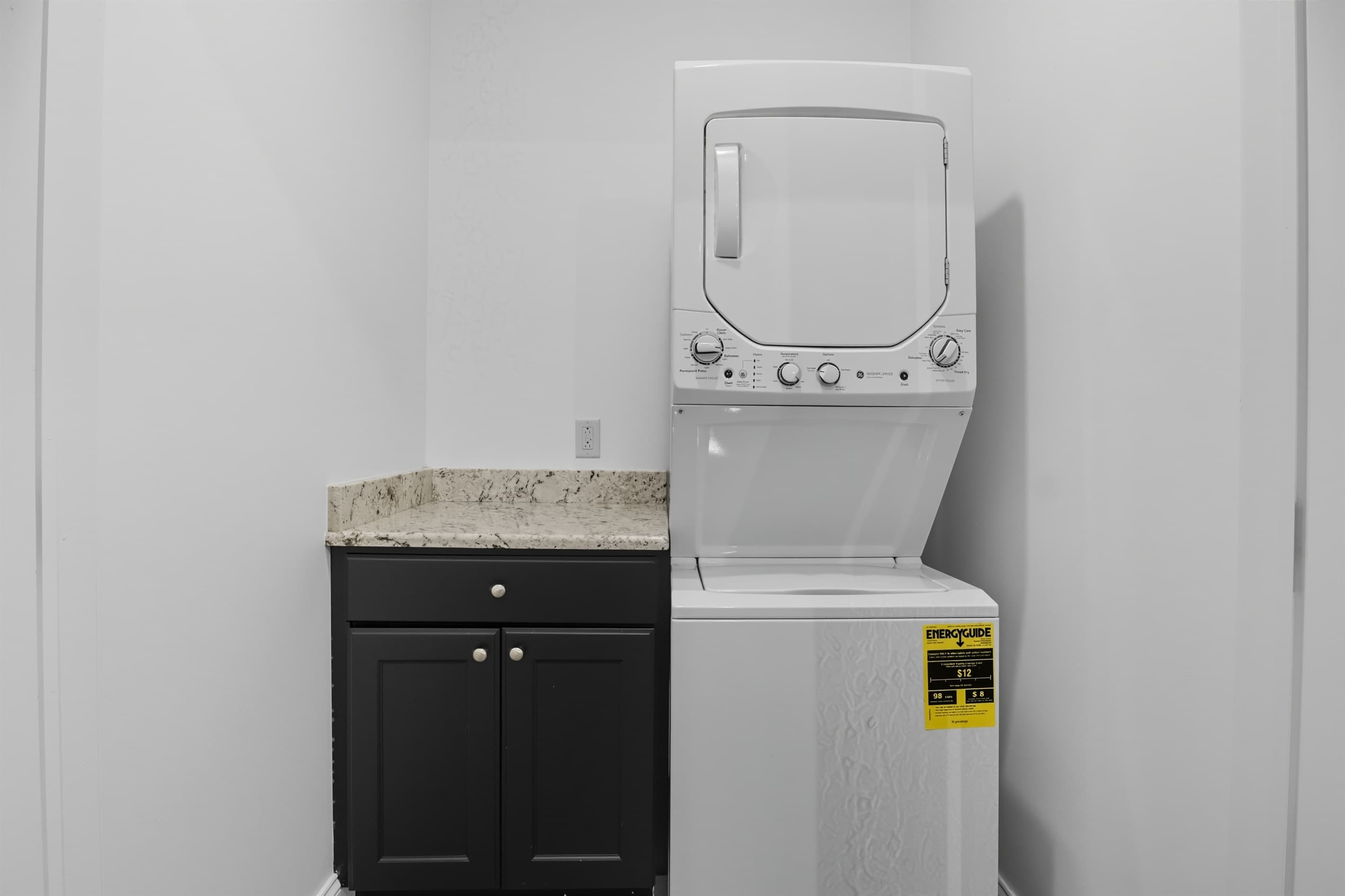 Lower-level laundry area with storage cabinet