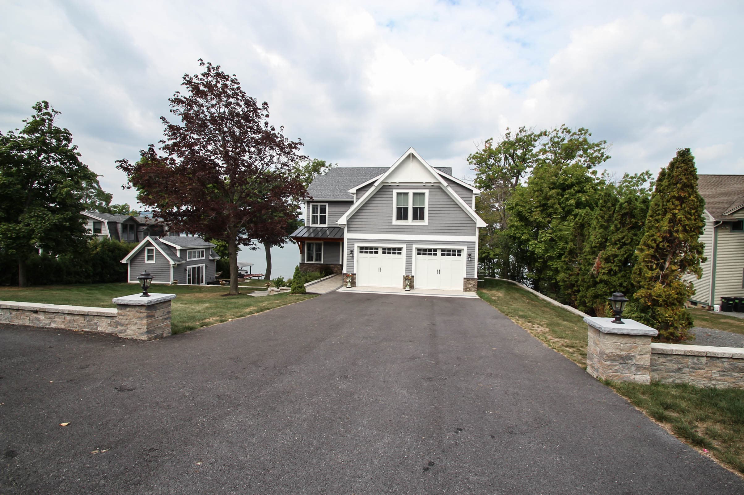 Front exterior with wide paved driveway
