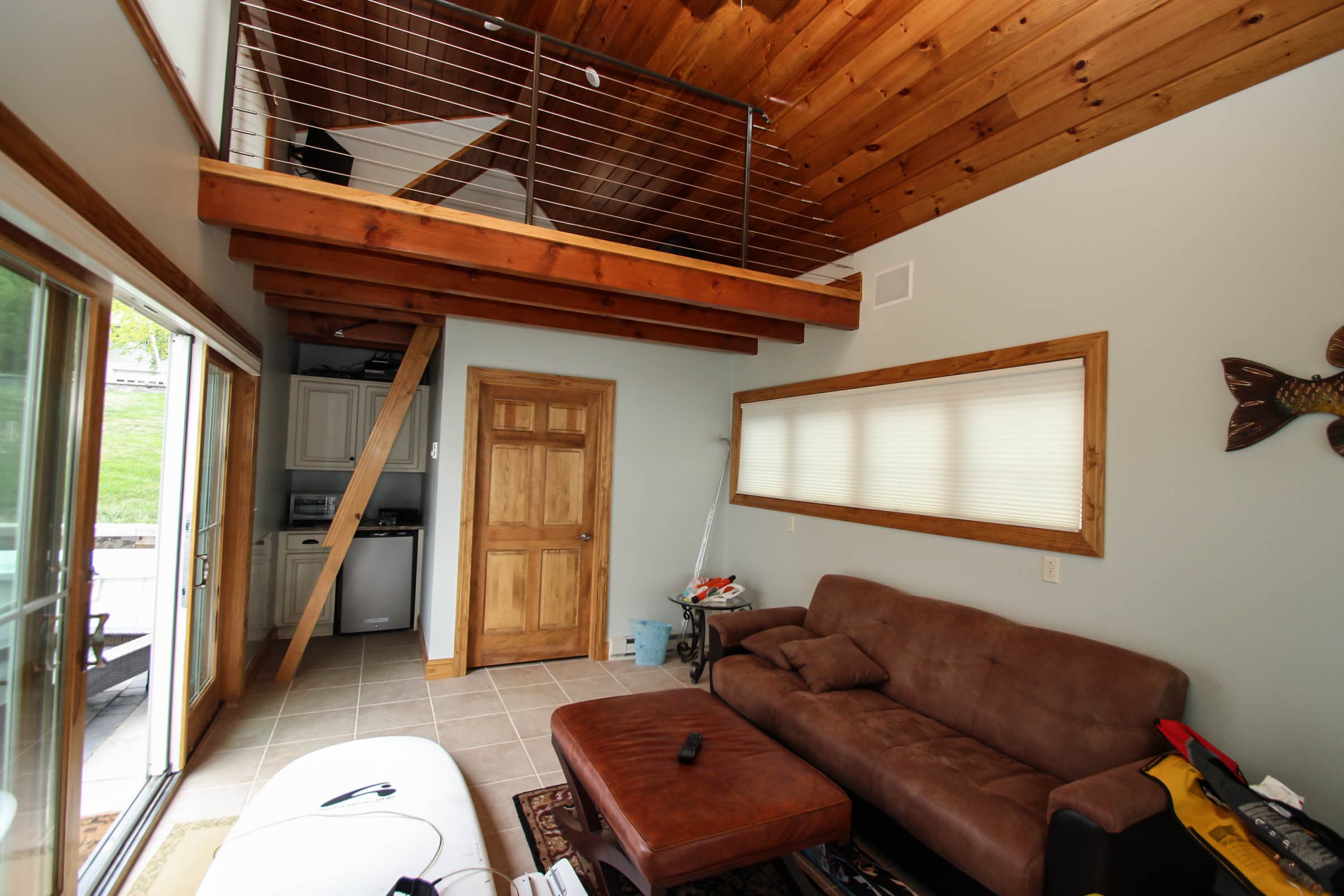 Living area beneath open wooden loft