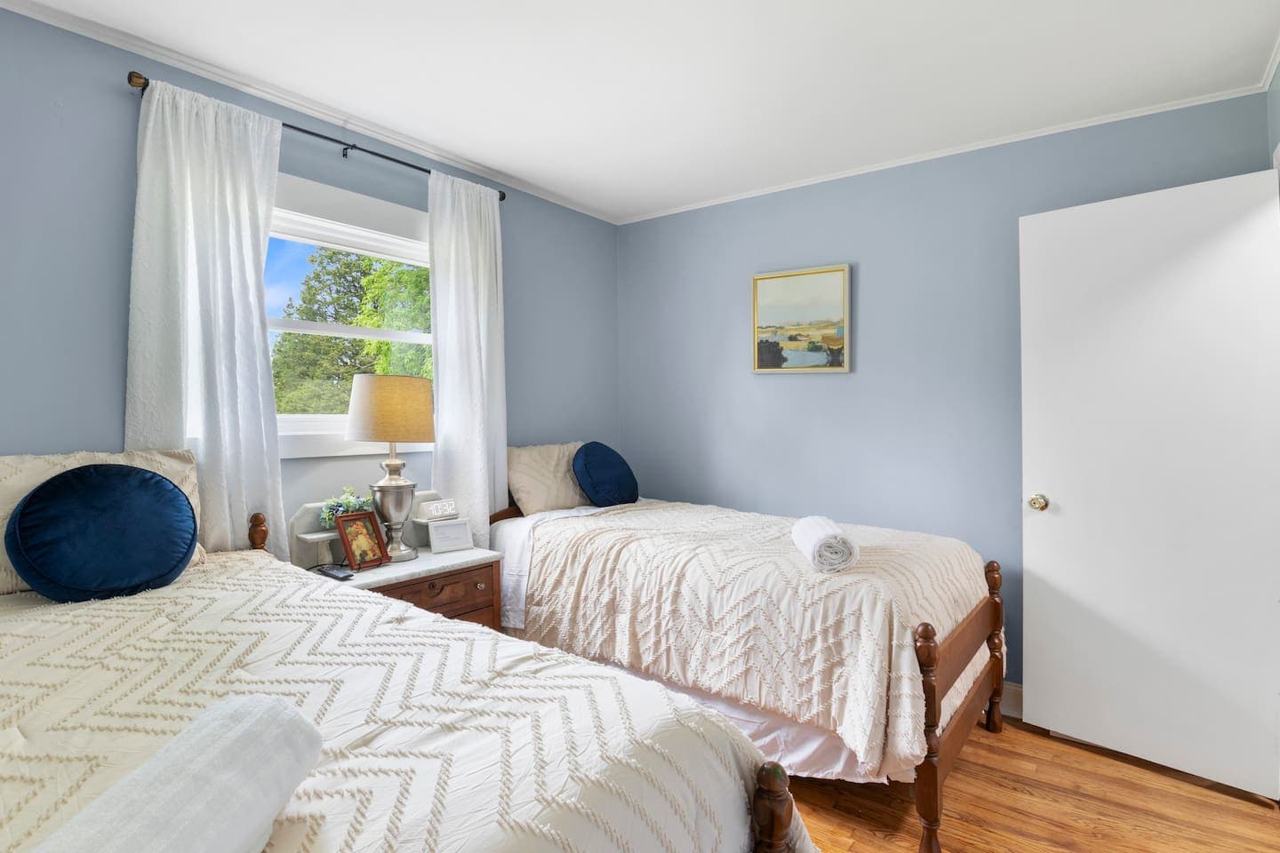 Bed positioned beneath wide window