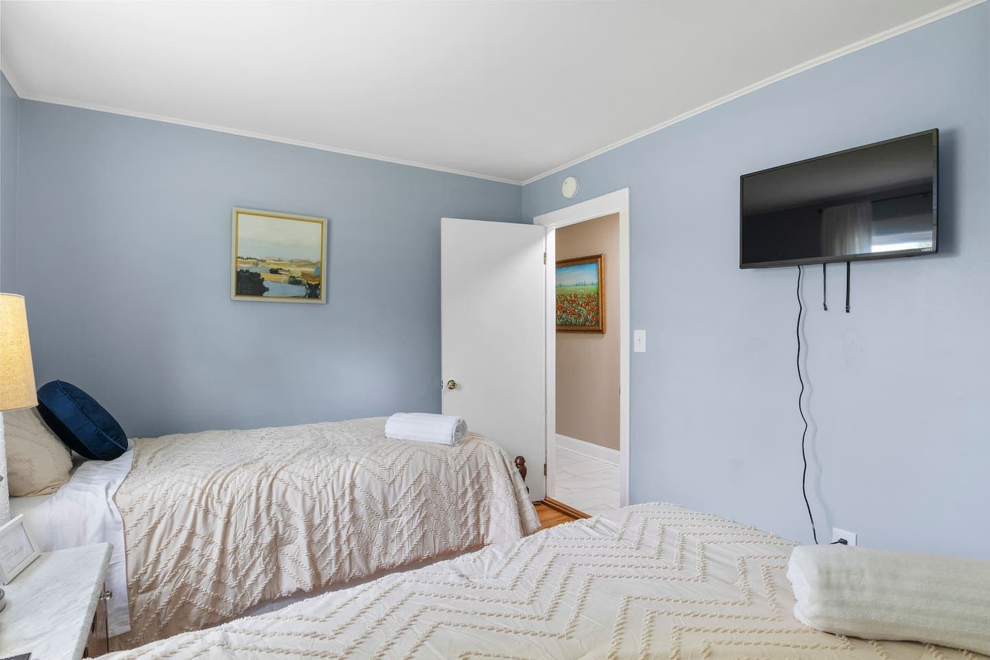 Wall-mounted television facing the bed