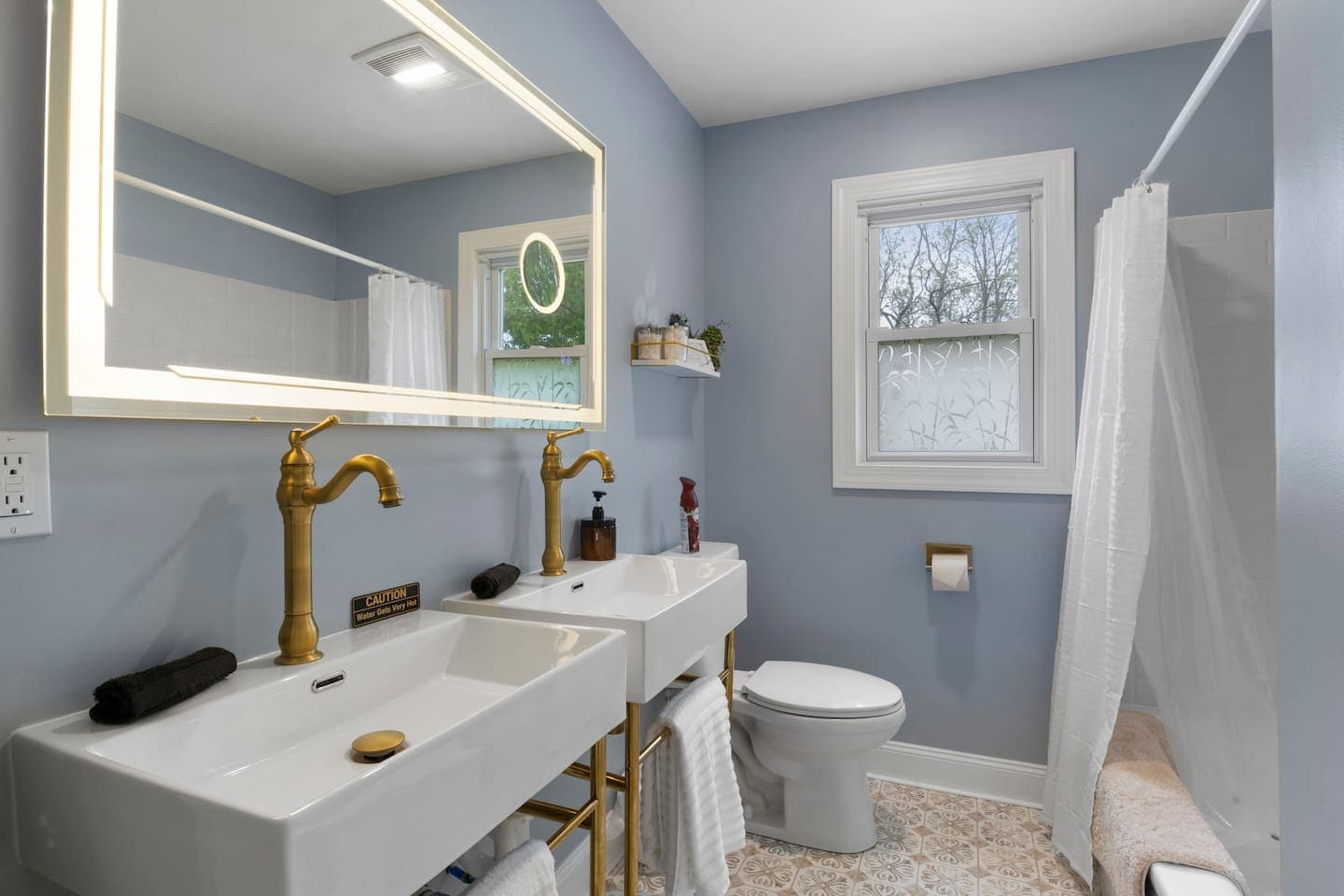 Bathroom vanity beside curtained tub and shower