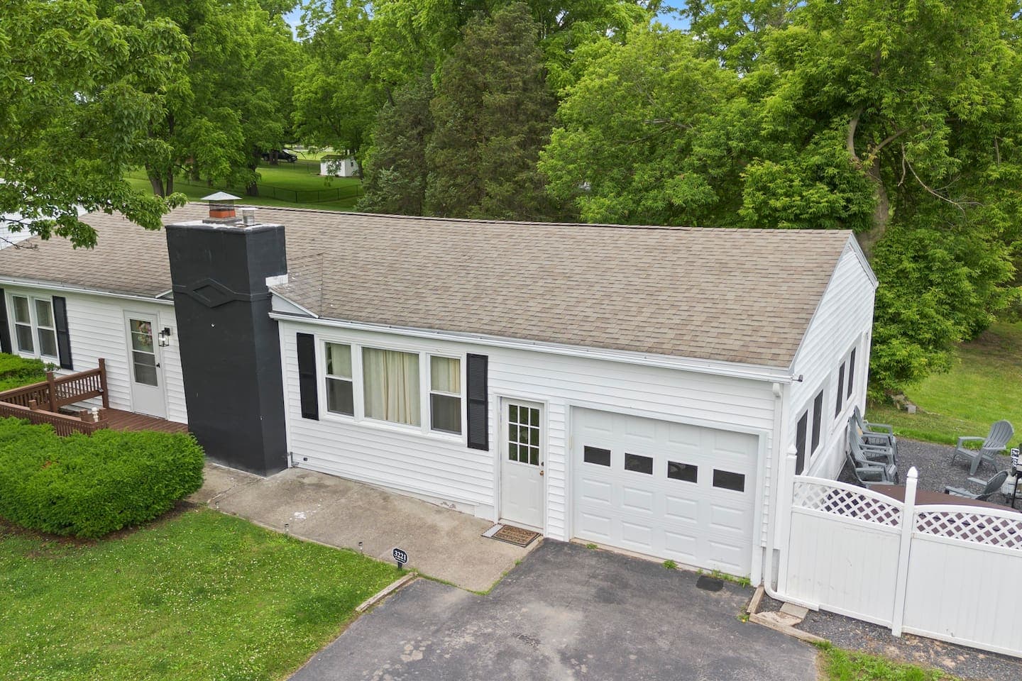Attached garage beside paved driveway
