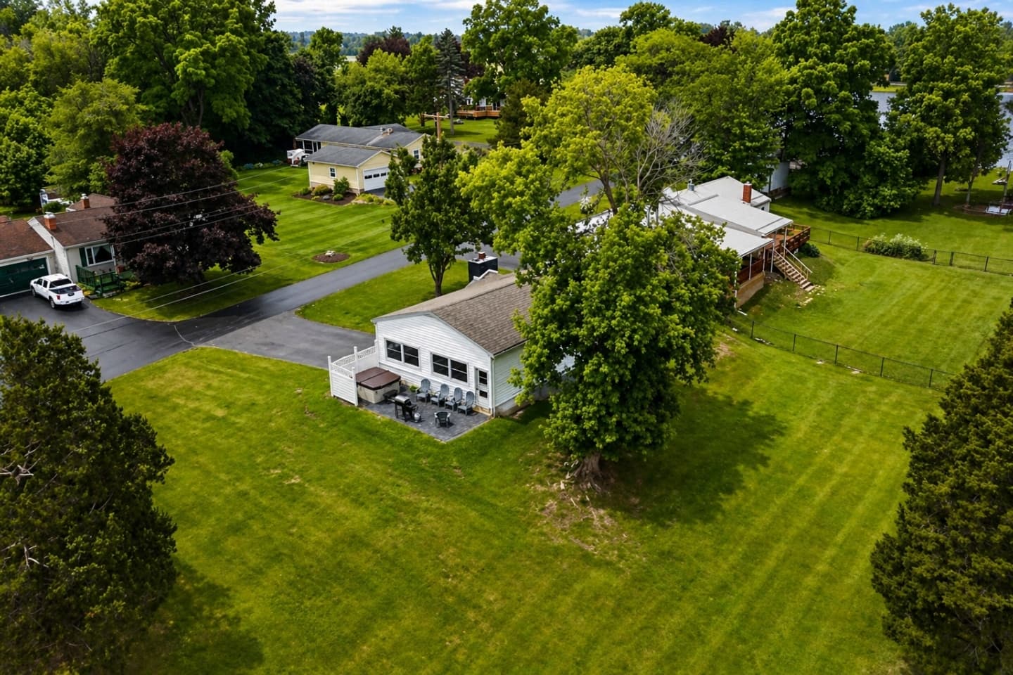 Home surrounded by expansive green lawn