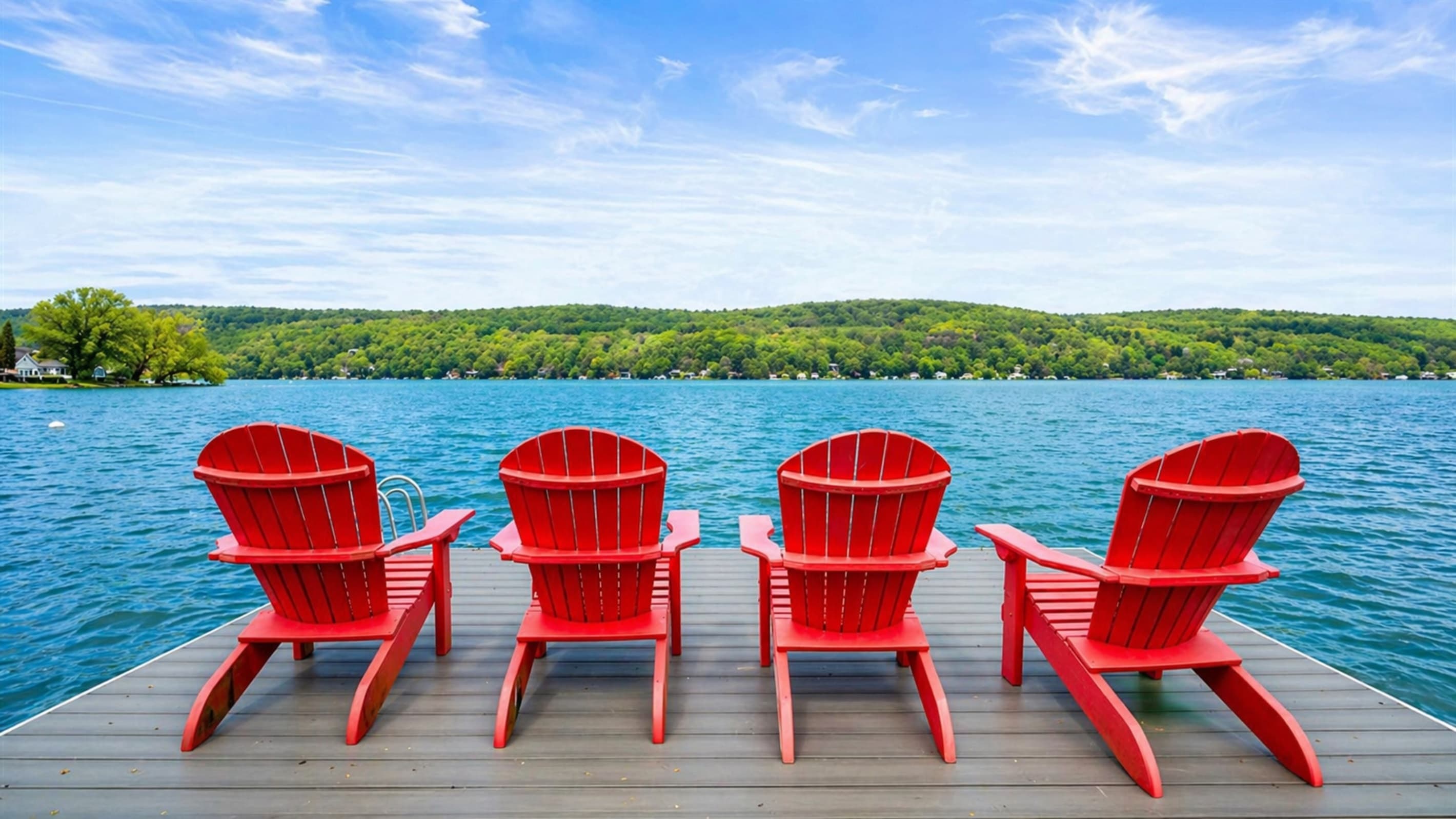 Four red chairs along the waterfront