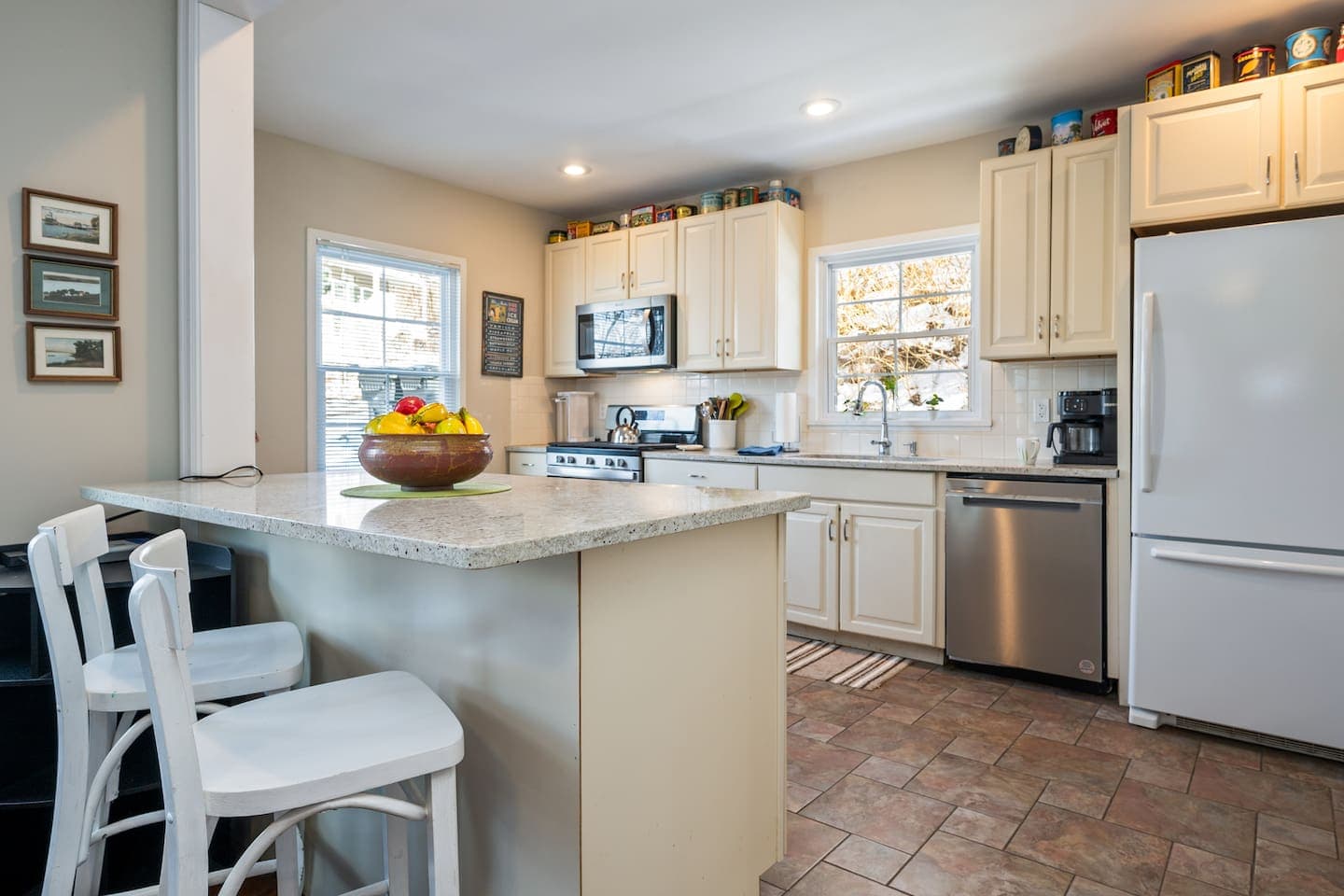Kitchen with white cabinetry and breakfast bar