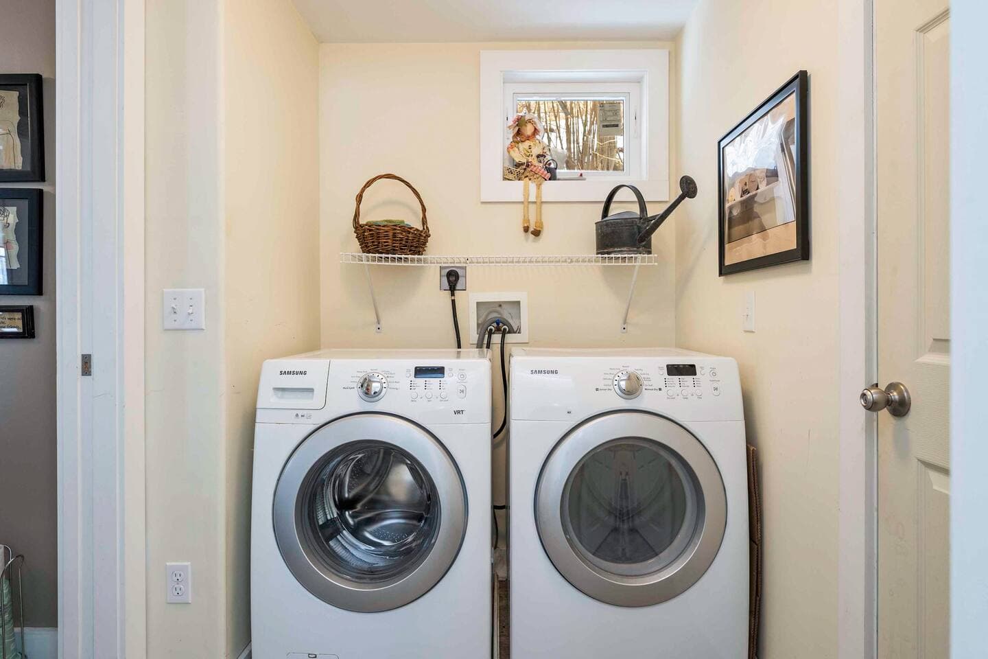 Washer and dryer beneath white shelves