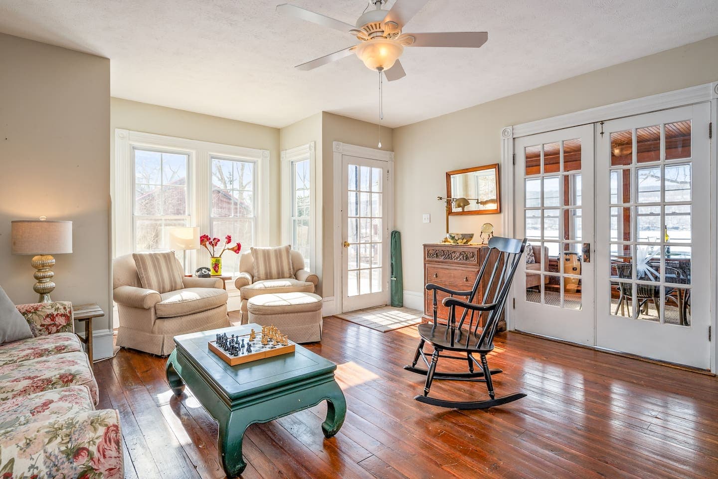 Sitting area surrounded by windows and glass doors