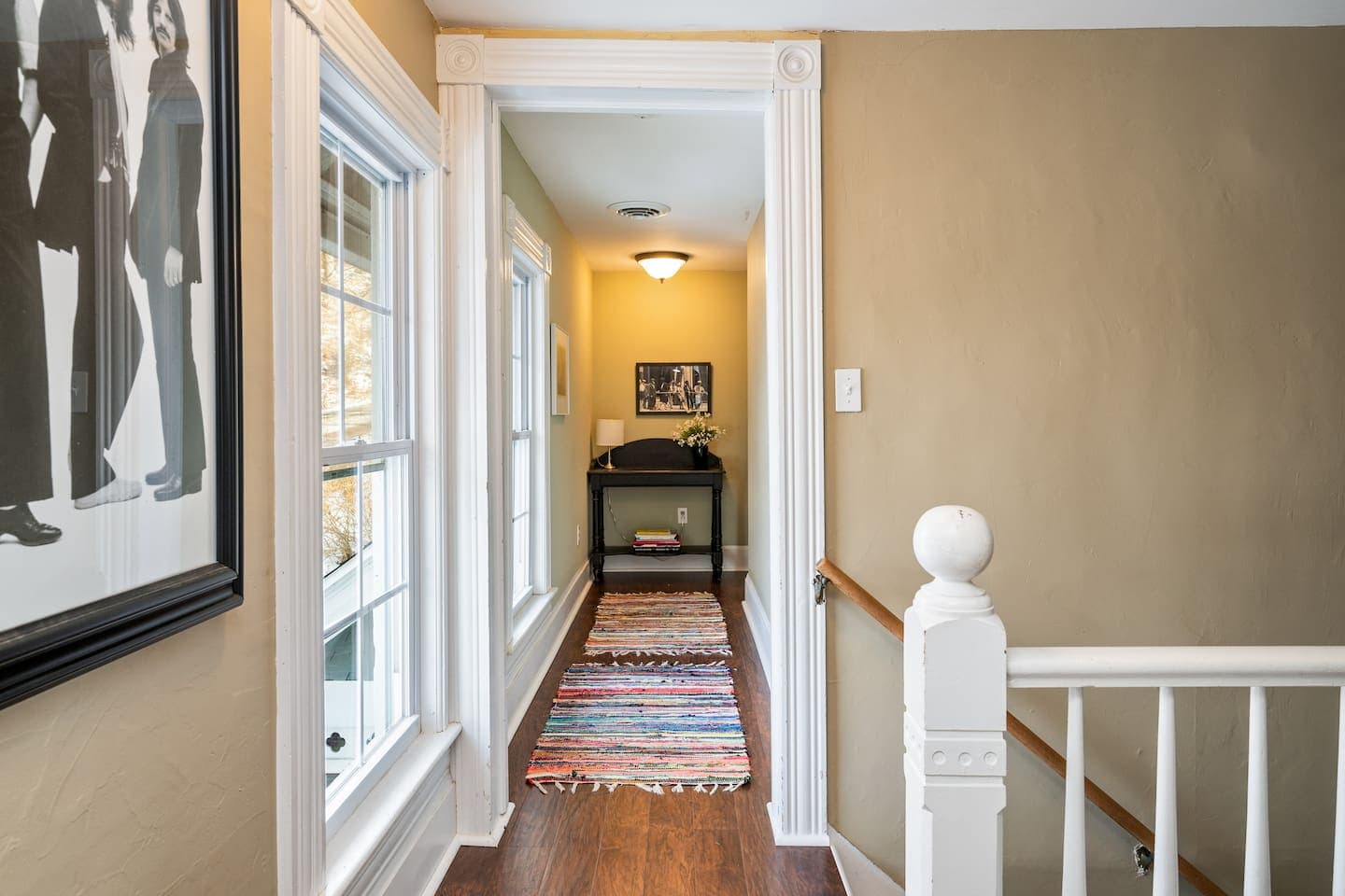 Upstairs hallway with railing and staircase