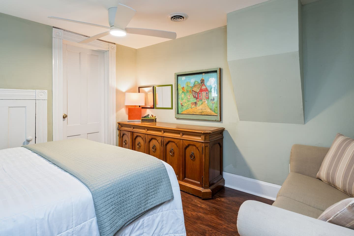 Bedroom dresser beneath framed artwork