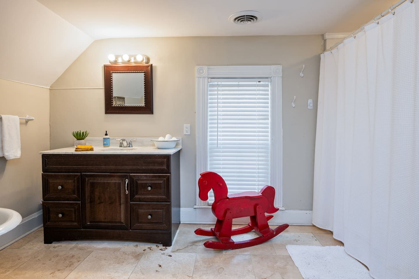 Bathroom with dark vanity and shower curtain