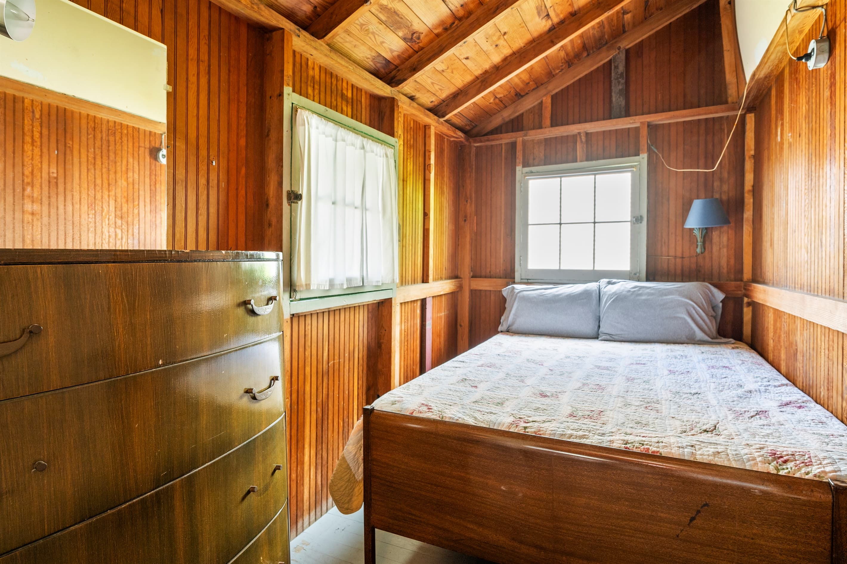Bedroom with wood-paneled walls