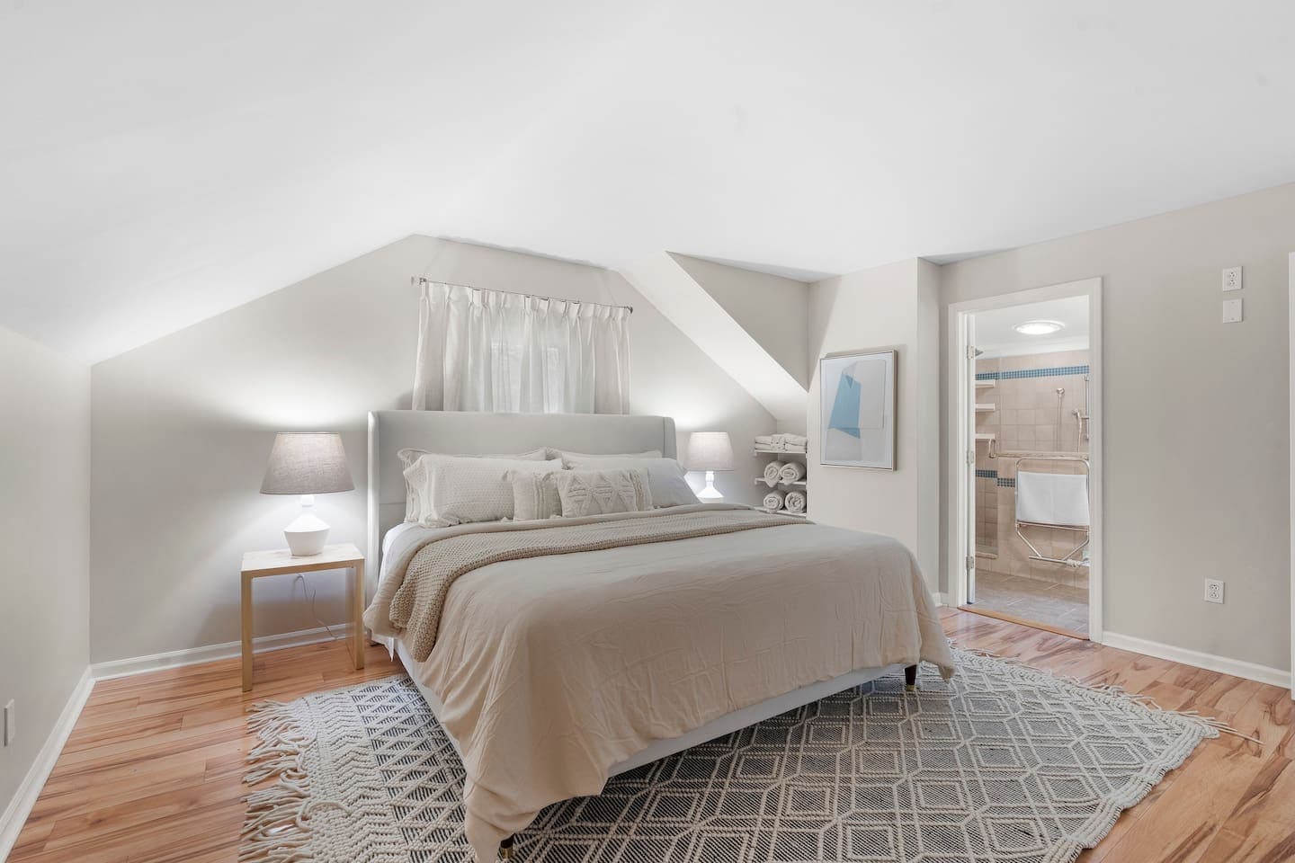 Bed beneath a sloped ceiling