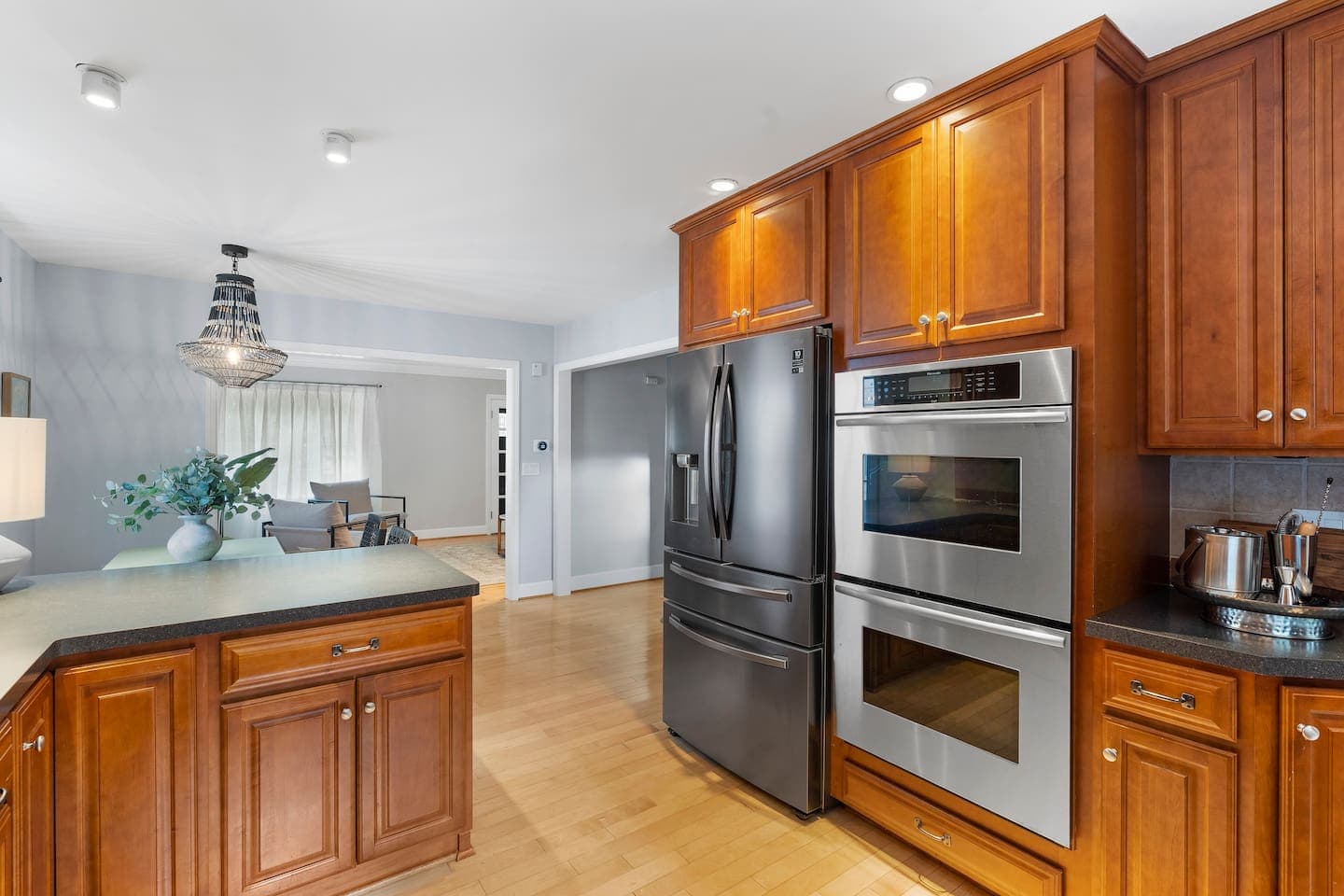 Stainless steel appliances among wood cabinetry