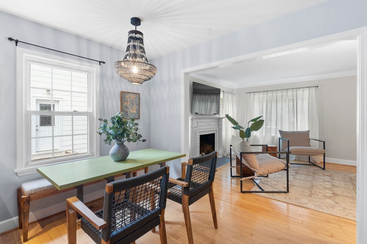 Wooden dining table beneath pendant lighting