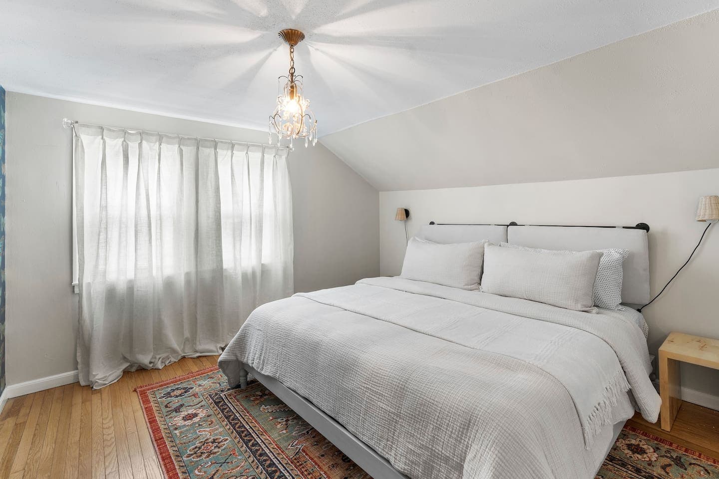 Bedroom with white bedding and curtains