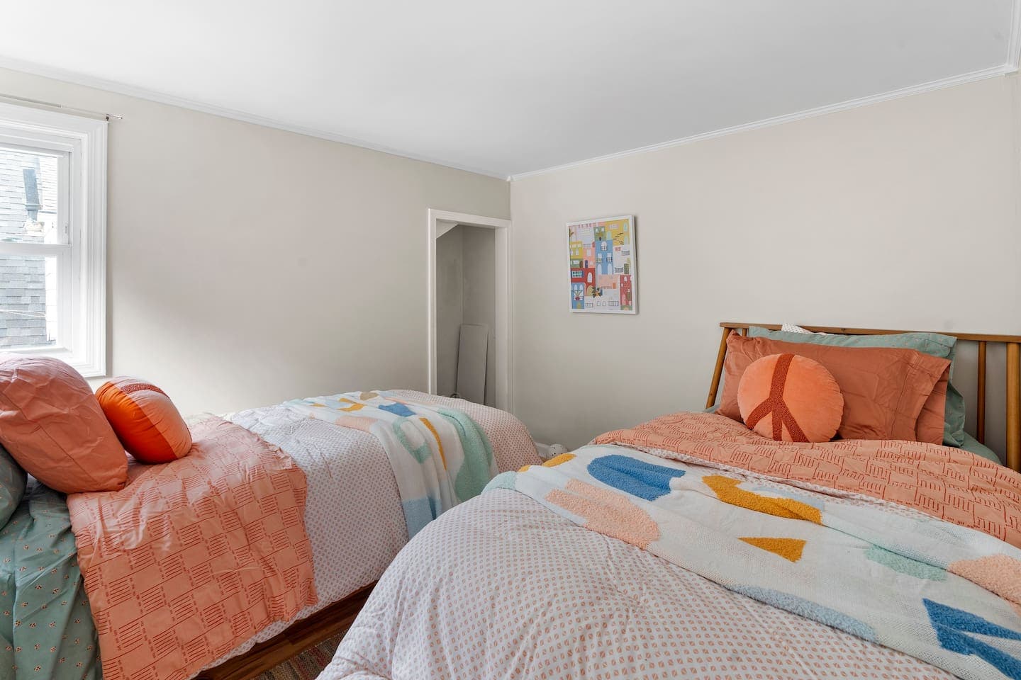 Two beds with colorful bedding