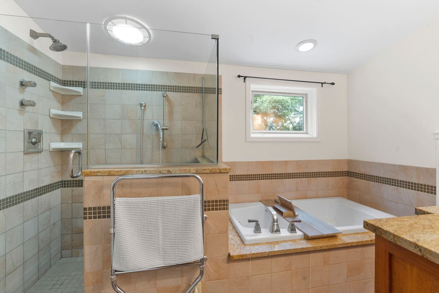 Glass-enclosed shower with tiled walls