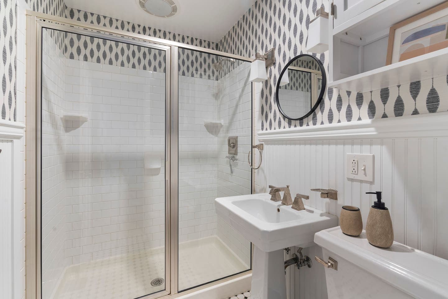 Bathroom vanity beneath round mirror