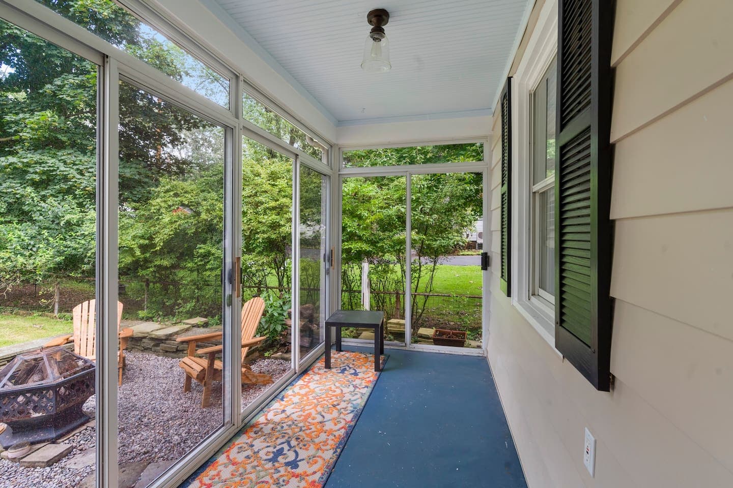 Patio seating beyond open doors