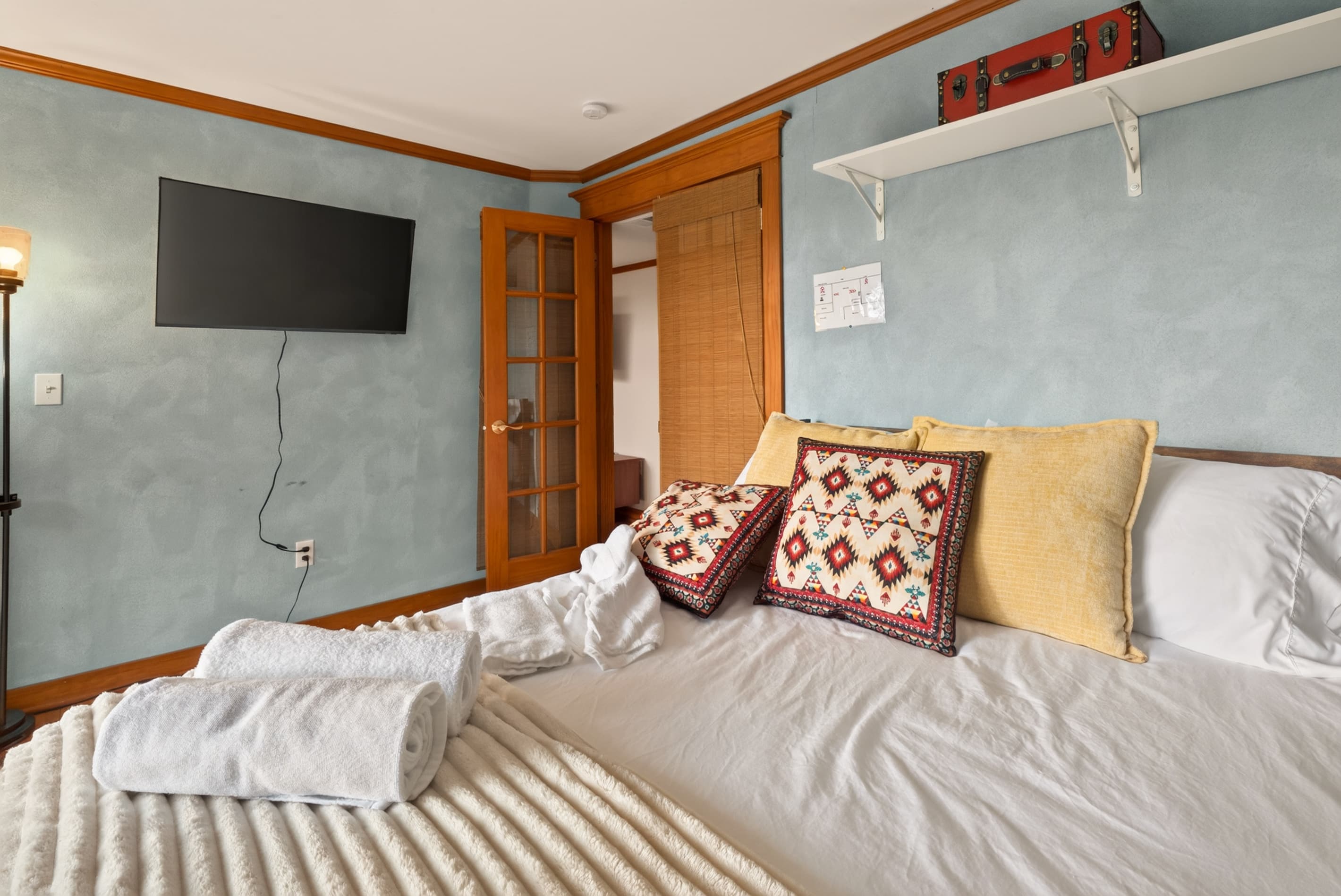 Bedroom with wall-mounted television