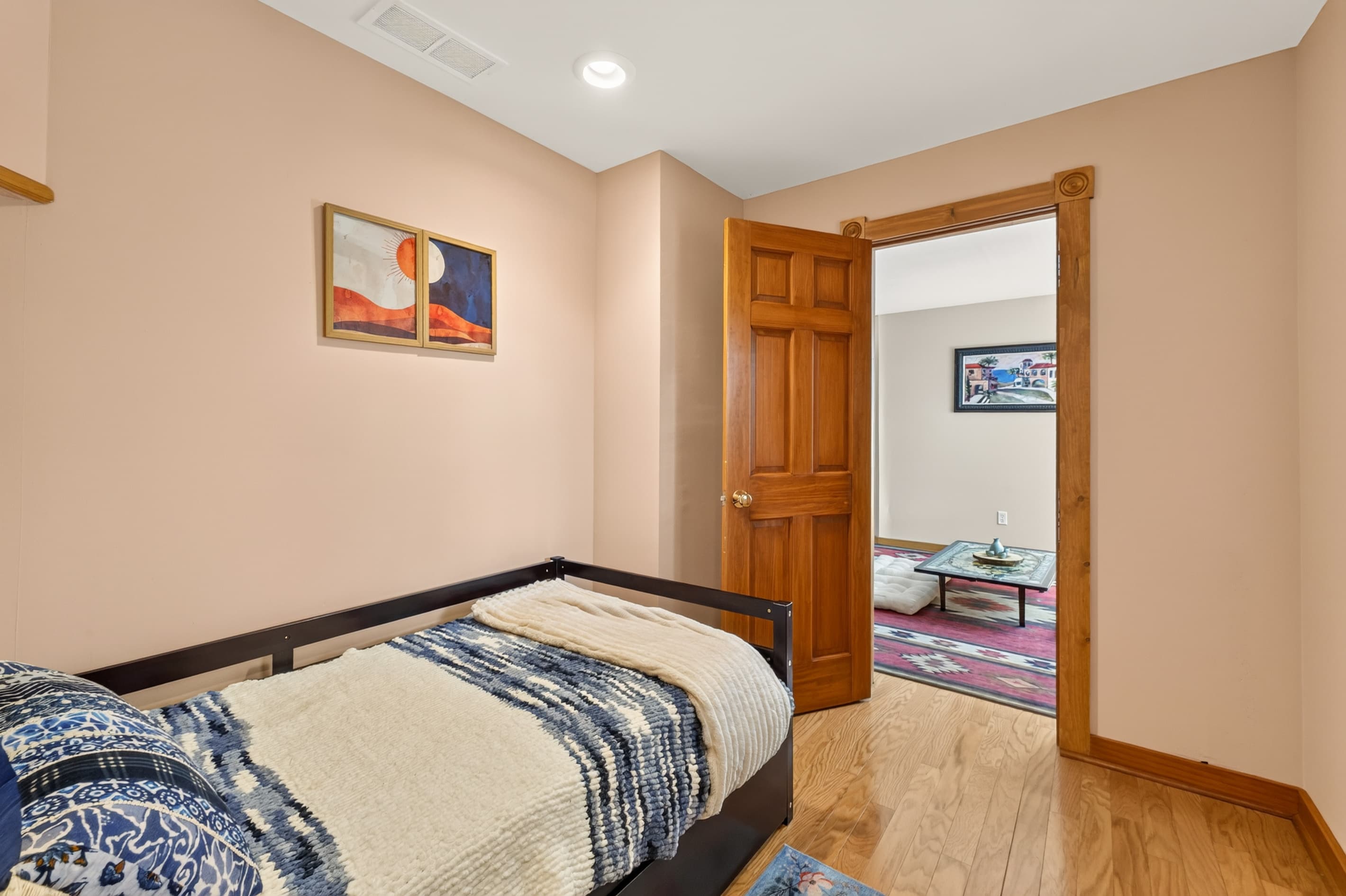 Bedroom with patterned bedding and doorway