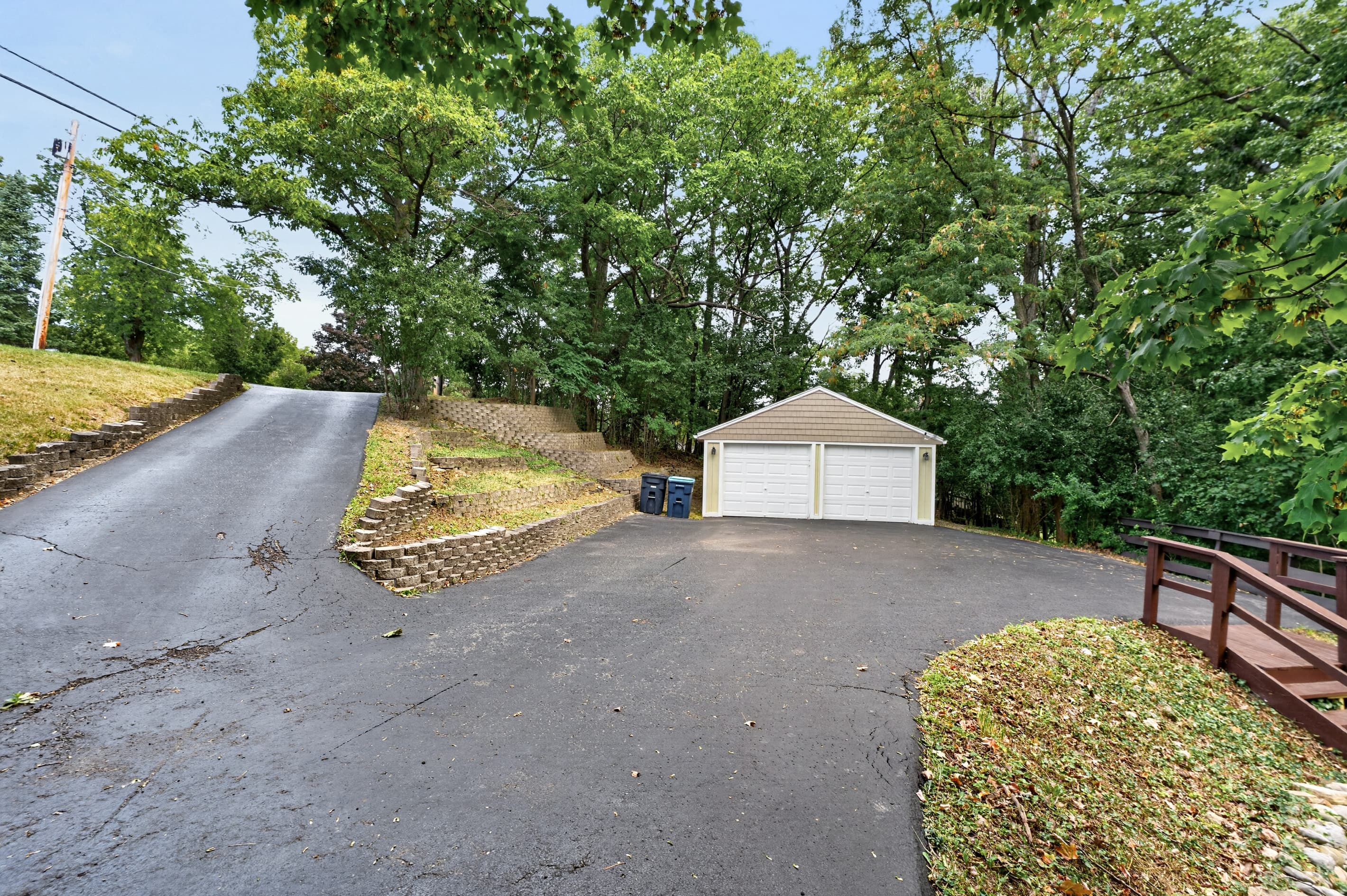Paved driveway leading to detached garage
