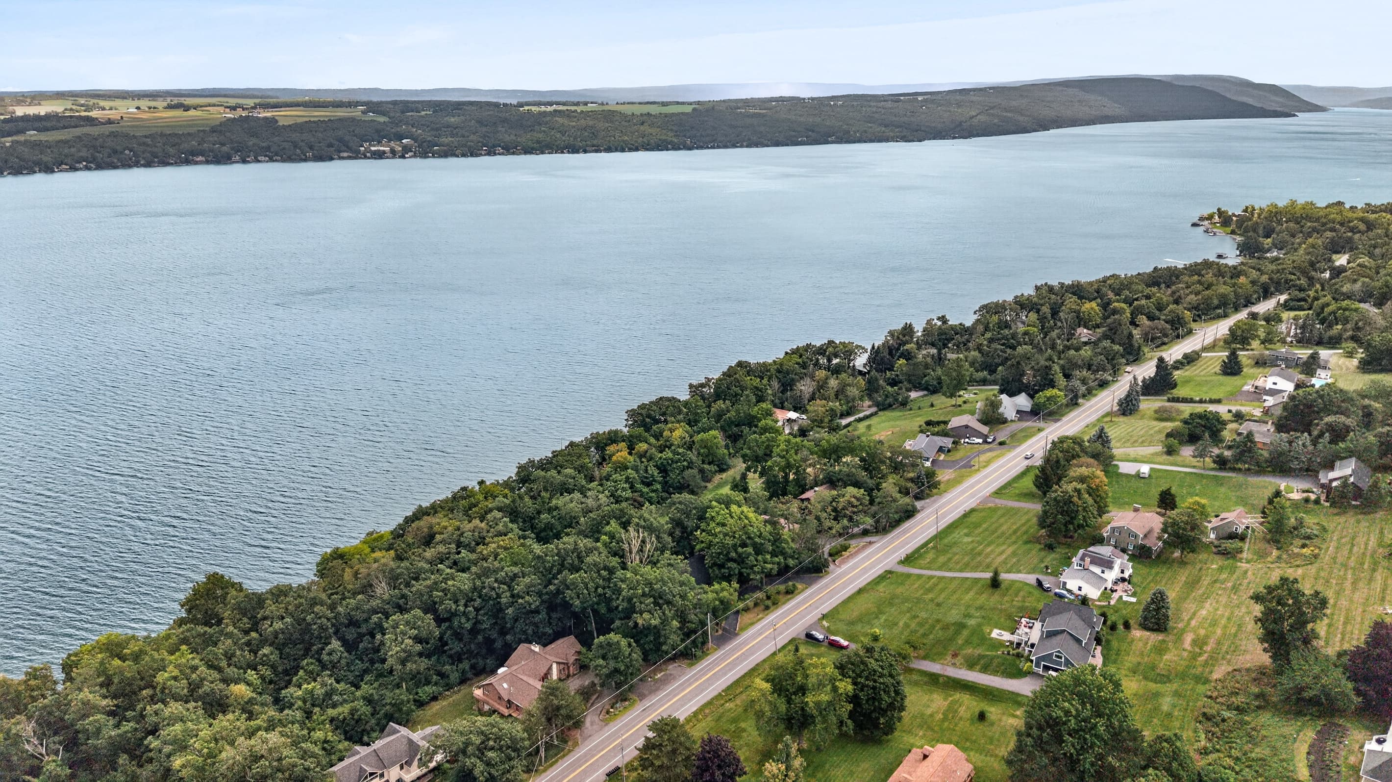 Lakeside road following the wooded shoreline