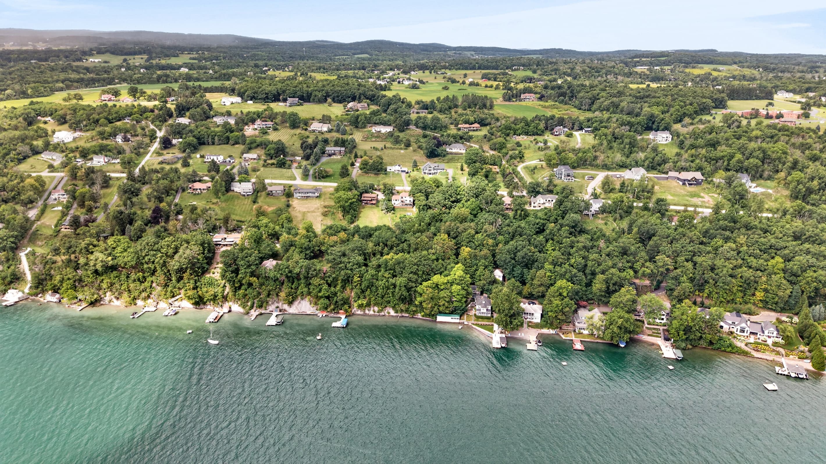 Homes lining the tree-covered waterfront
