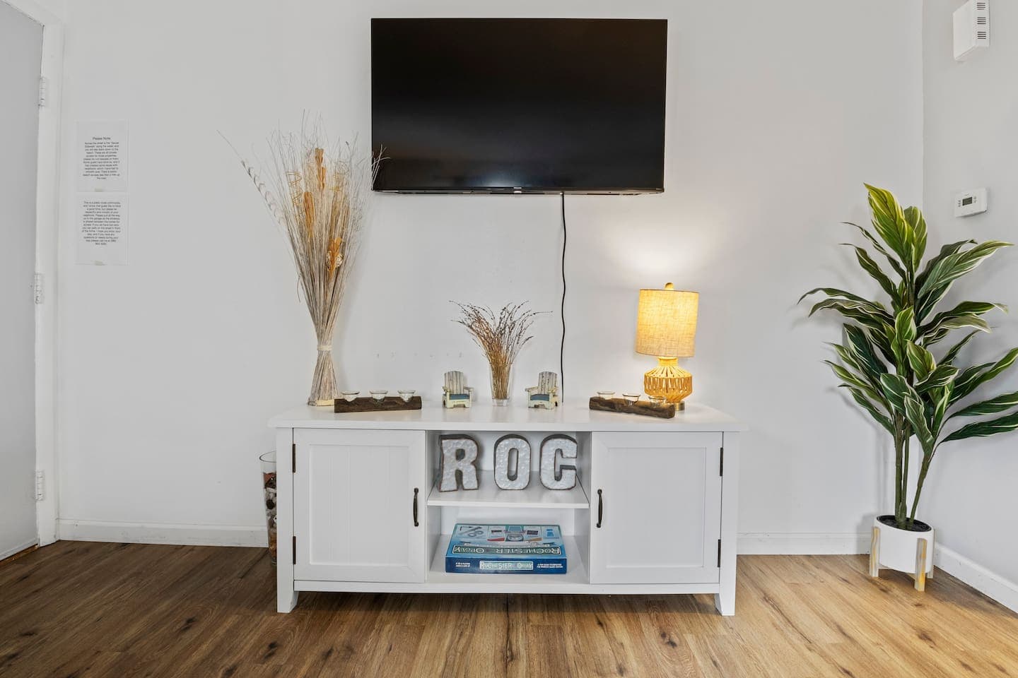 White console beneath the wall mounted TV