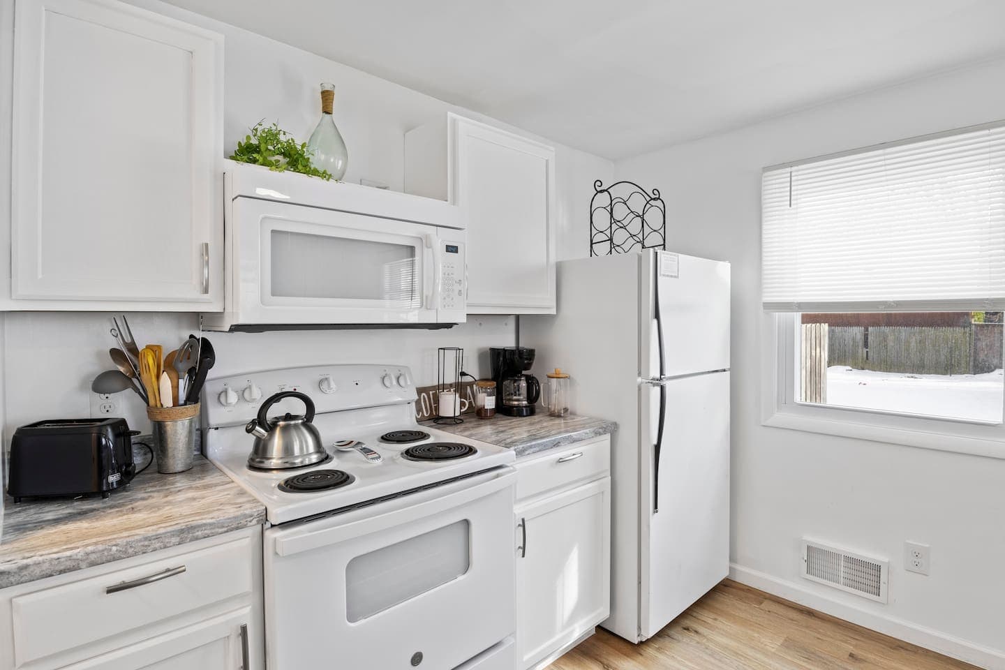 Fully-equipped kitchen with white appliances