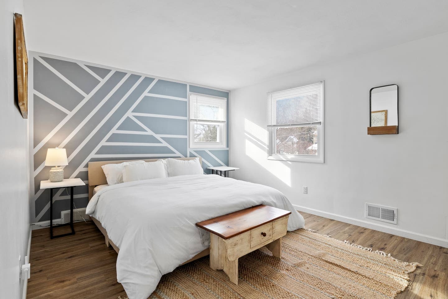 Bed against geometric accent wall