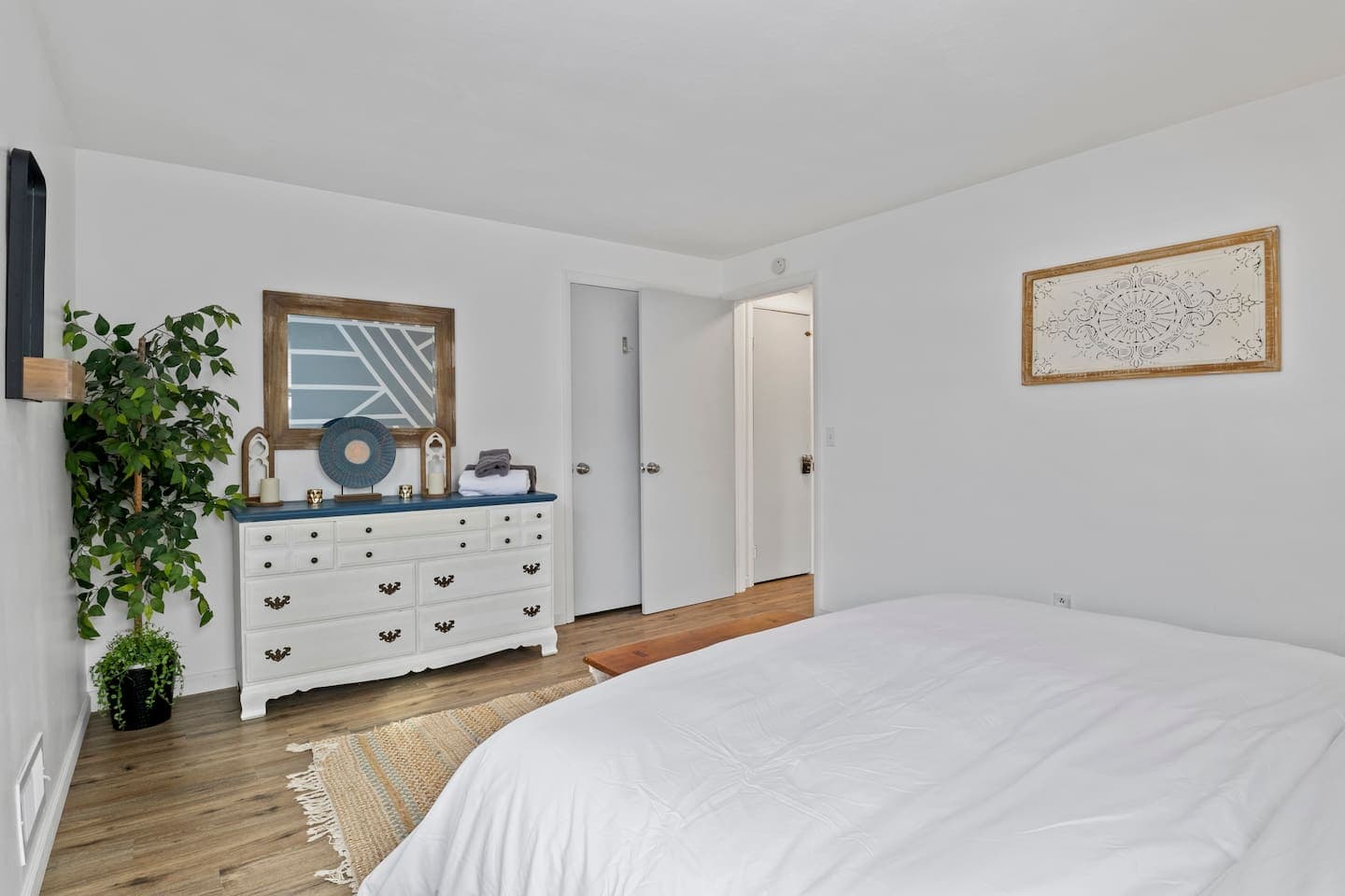 White dresser beneath the framed mirror