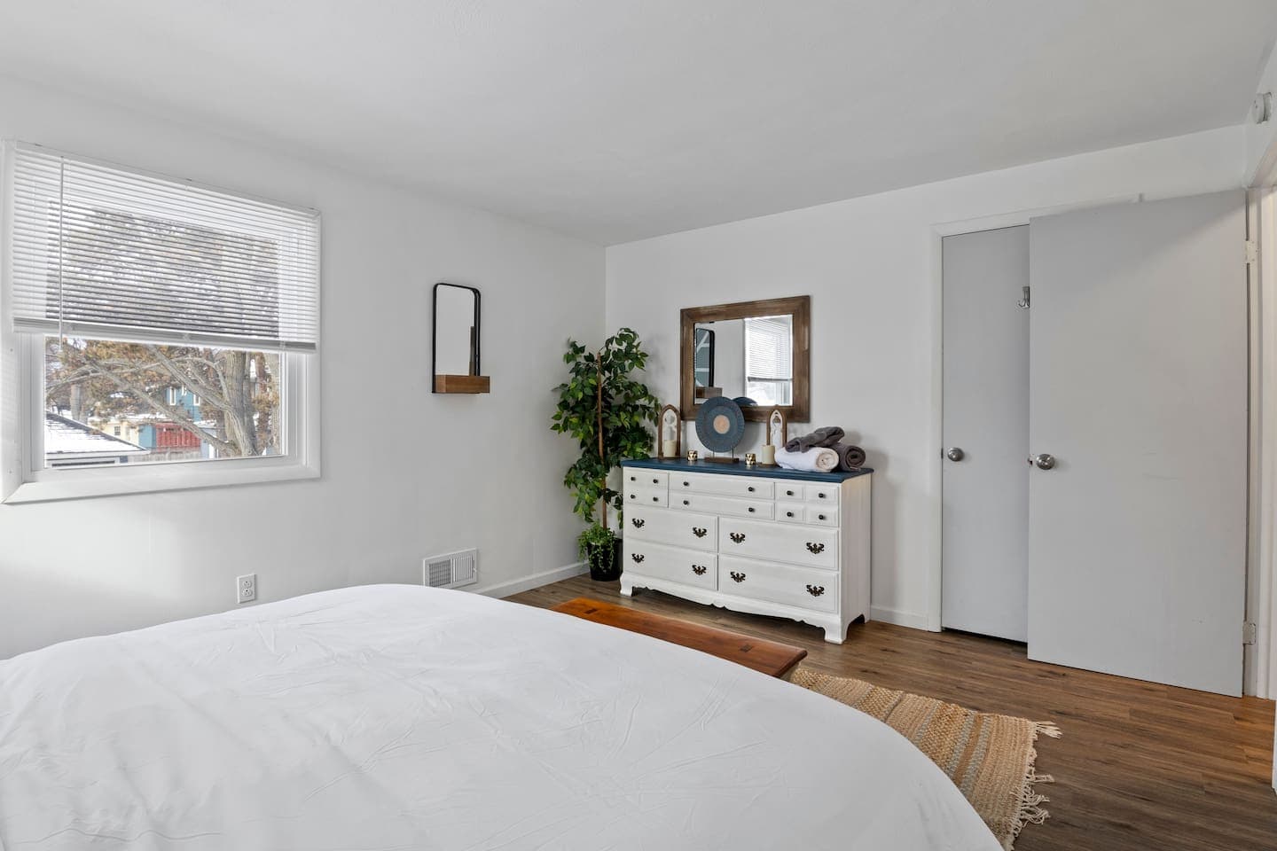 Bedroom with white dresser and vanity mirror 