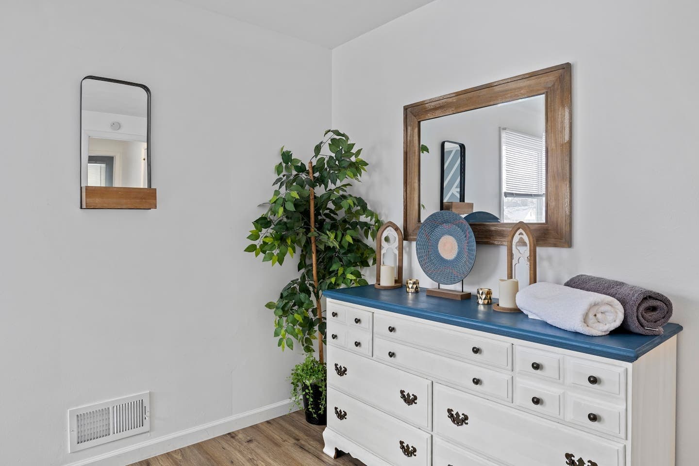 Dresser topped with decor and linens