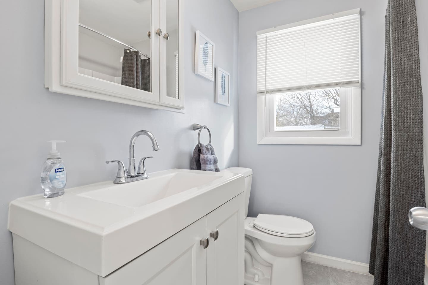 Bathroom vanity with sink and wall mirror