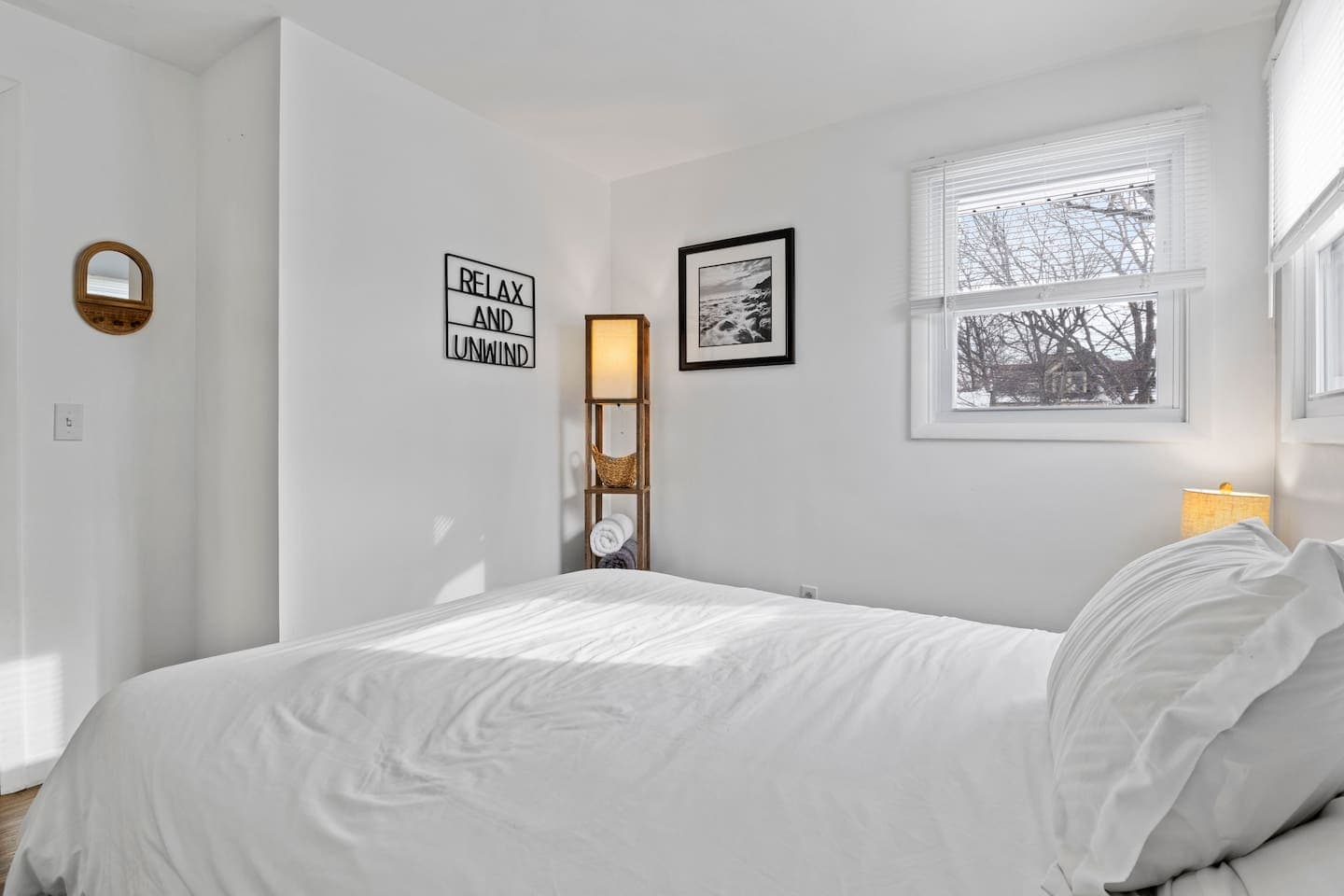 Bedroom with two windows and black/ white art decor