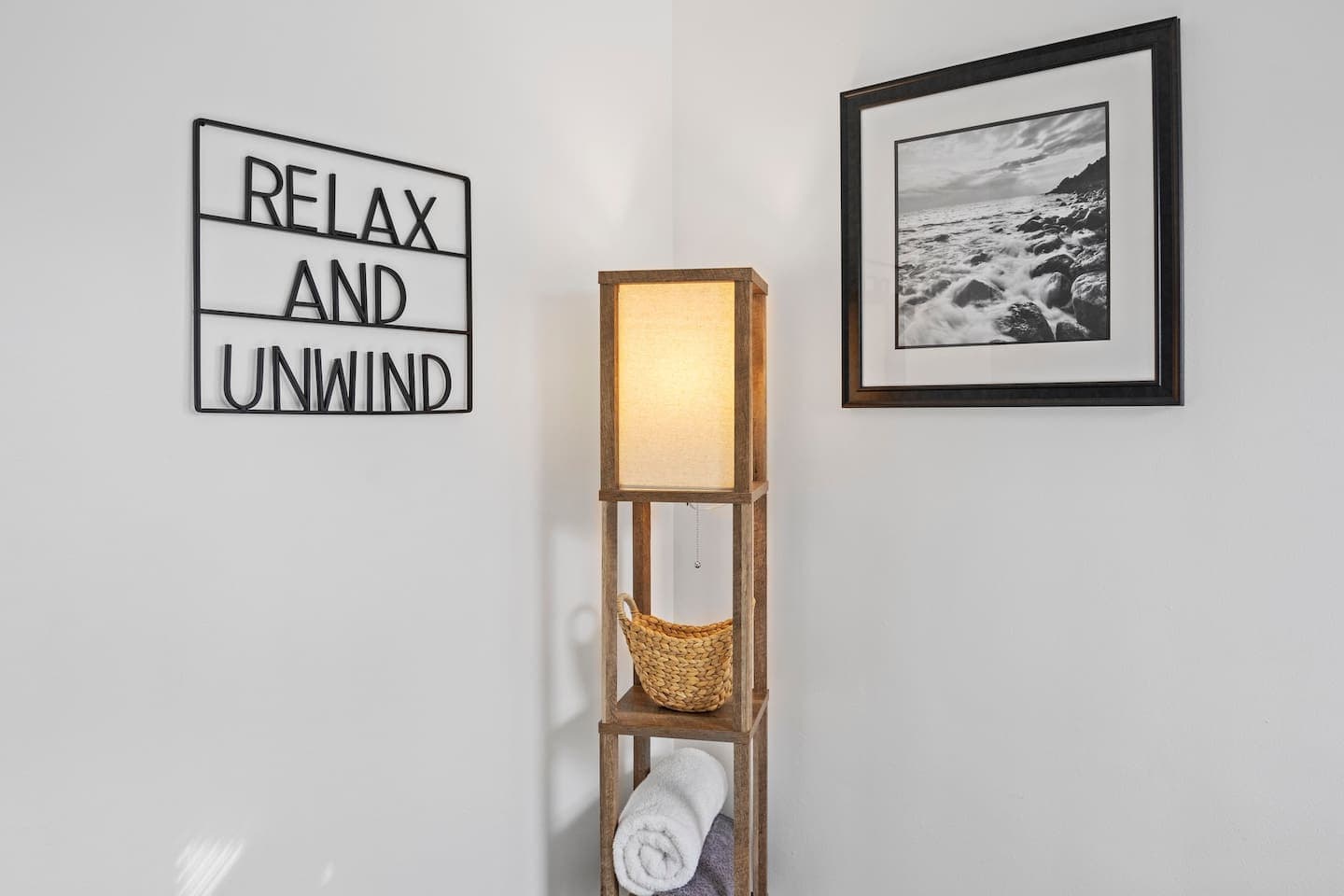Bedroom wall decor and wooden shelves with linens