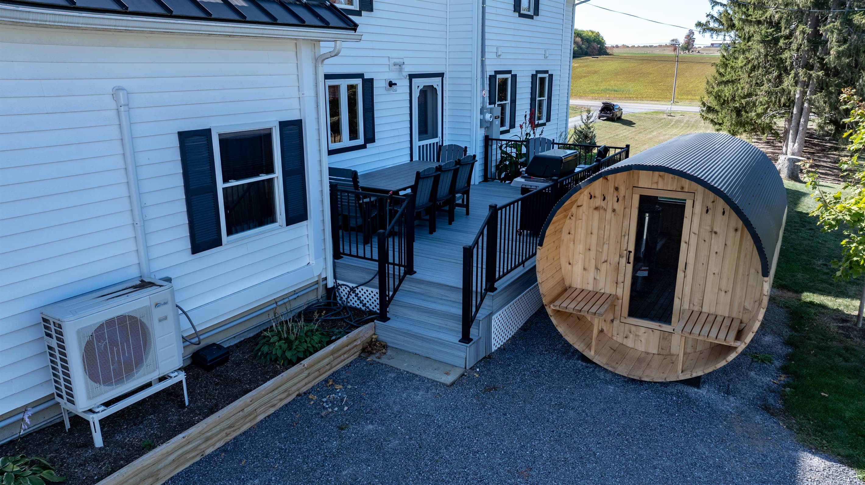 Outdoor barrel sauna beside the house