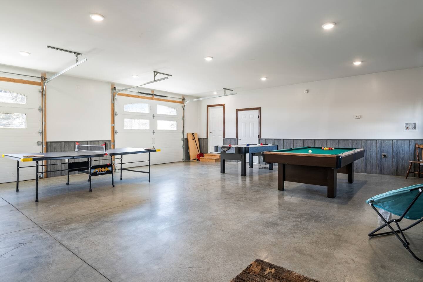 Game room with pool table, air hockey game and ping pong table